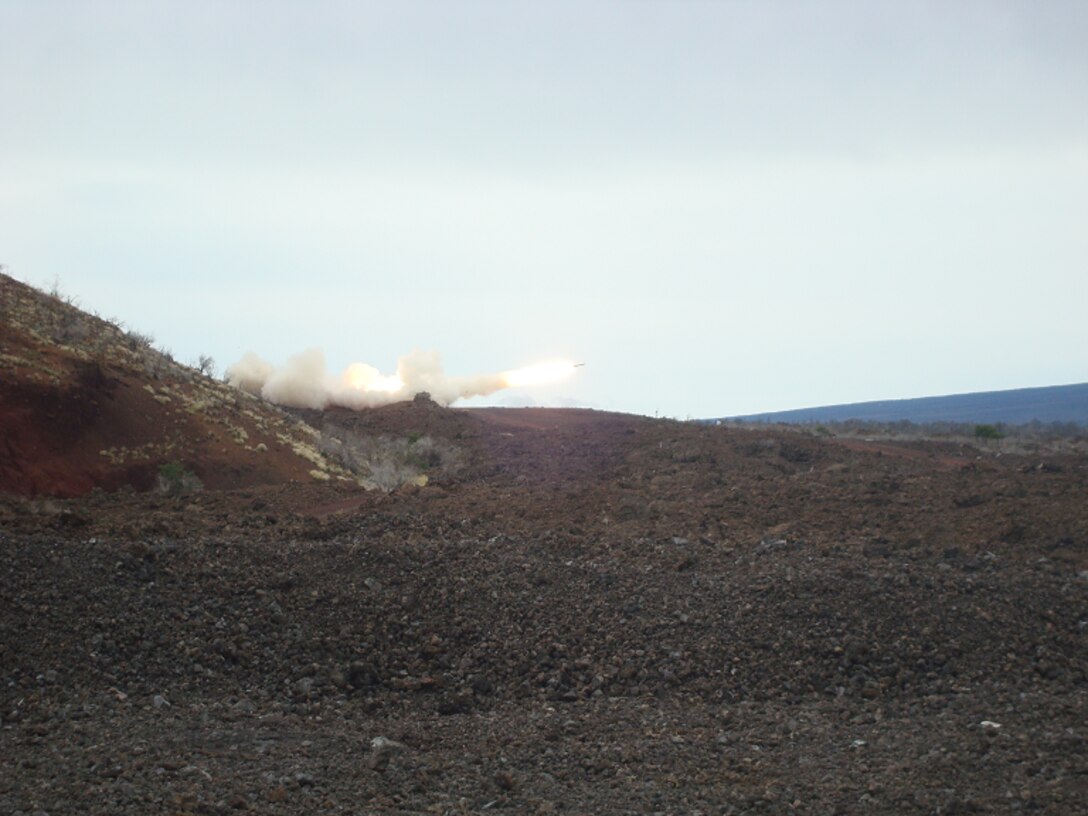 A M142 HIMARS launcher from Battery R fires a M28A2 rocket during a live fire training event at Pohakuloa Training Area, Hawaii.