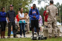 Staff Sgt. Samuel Beltram, the training chief with Explosive Ordinance Disposal Company, 8th Engineer Support Battalion, 2nd Marine Logistics Group, and a native of Fort Worth, Texas, explains the importance of thinking ahead while using robots to students at Lejeune High School, Oct. 3, 2014 aboard Marine Corps Base Camp Lejeune, N.C.  Approximately 60 students, ranging from freshmen to seniors, packed the classroom to hear how the Marines use robotics on the battlefield and how engineering can better people’s lives. The school requested the Marines give the demonstration because the students are beginning their robotics curriculum of the Bio-Tech Department course of study.  (U.S. Marine Corps photo by Cpl. Michael Dye / Released)