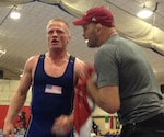 National Greco-Roman Coach Matt Lindland coaches Jon Anderson during the break in his 75 kg gold medal match at the CISM World Military Championships at Fort Dix, N.J.