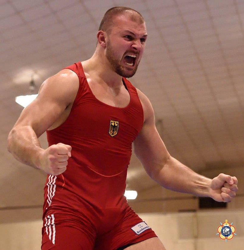 Germany's Johannes Kessel celebrates after winning gold over Kazakhstan's Dmitri Popov in the 125kg Men's Freestyle competition at the 29th CISM World Military Wresting Championship at Joint Base McGuire-Dix-Lakehurst, New Jersey 1-8 October.