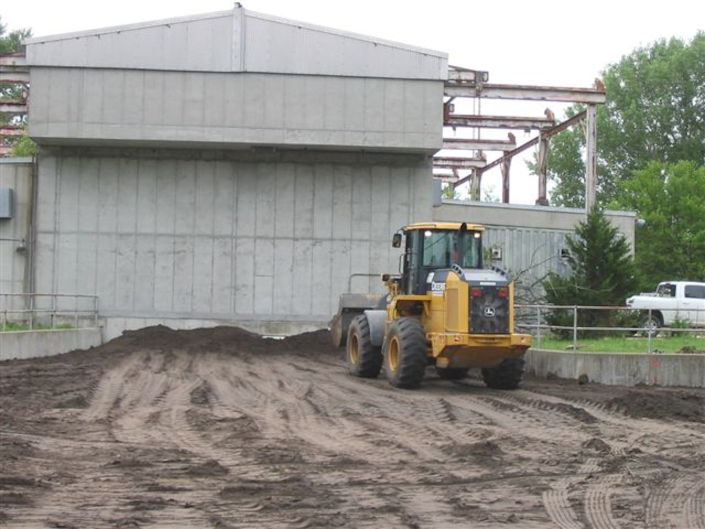To prepare the site for the thermal treatment technology ITSI Gilbane dewatered the Flame Pit Area behind LSB2 prior to backfillling it. 
Before dewatering, they collected a surface water sample and then monitored for contaminants as water was discharged to the ground outside the pit area to evaporate. With the go-ahead, they backfilled the FPA with 6,500 cu yds of clean sandy clay loam soil.