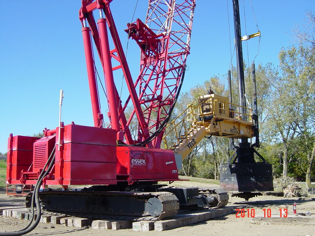 The mixing rig and a 200-ton crane were mobilized to the site. A rubber-tire hydraulic crane was used to unload the equipment, build the crawler crane, and place the component parts of the mixing rig in the site staging area located on the south side of LSB2 for rig assembly.