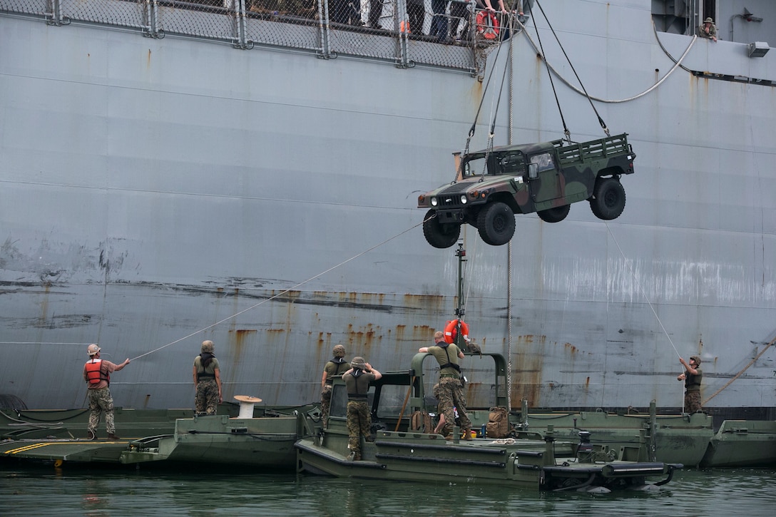 U.S. Marines load a Humvee onto an Improved Ribbon Bridge component while executing ship-to-shore transport operations Sept. 24 in logistical support of Amphibious Landing Exercise 2015 in Subic Bay, Philippines. The operation proved the concept that IRB components can be used in conjunction with Bridge Erection Boats on the open ocean as a ship-to-shore connector for transporting supplies and equipment to Marines on shore. PHIBLEX is an annual bilateral training exercise conducted by the Armed Forces of the Philippines alongside U.S. Marine and Navy forces. The Marines are combat engineers with 9th Engineer Support Battalion, 3rd Marine Logistics Group, III Marine Expeditionary Force, currently assigned to Combat Logistics Detachment 379, Headquarters Regiment, 3rd MLG, III MEF. T-AKE 14-2 is a maritime pre-positioned force, multi-country theater security cooperation event that deployed from Okinawa aboard the USNS Sacagawea to participate in training exercises throughout the Asia-Pacific area of operations. (U.S. Marine Corps photo by Cpl. Drew Tech/Released)