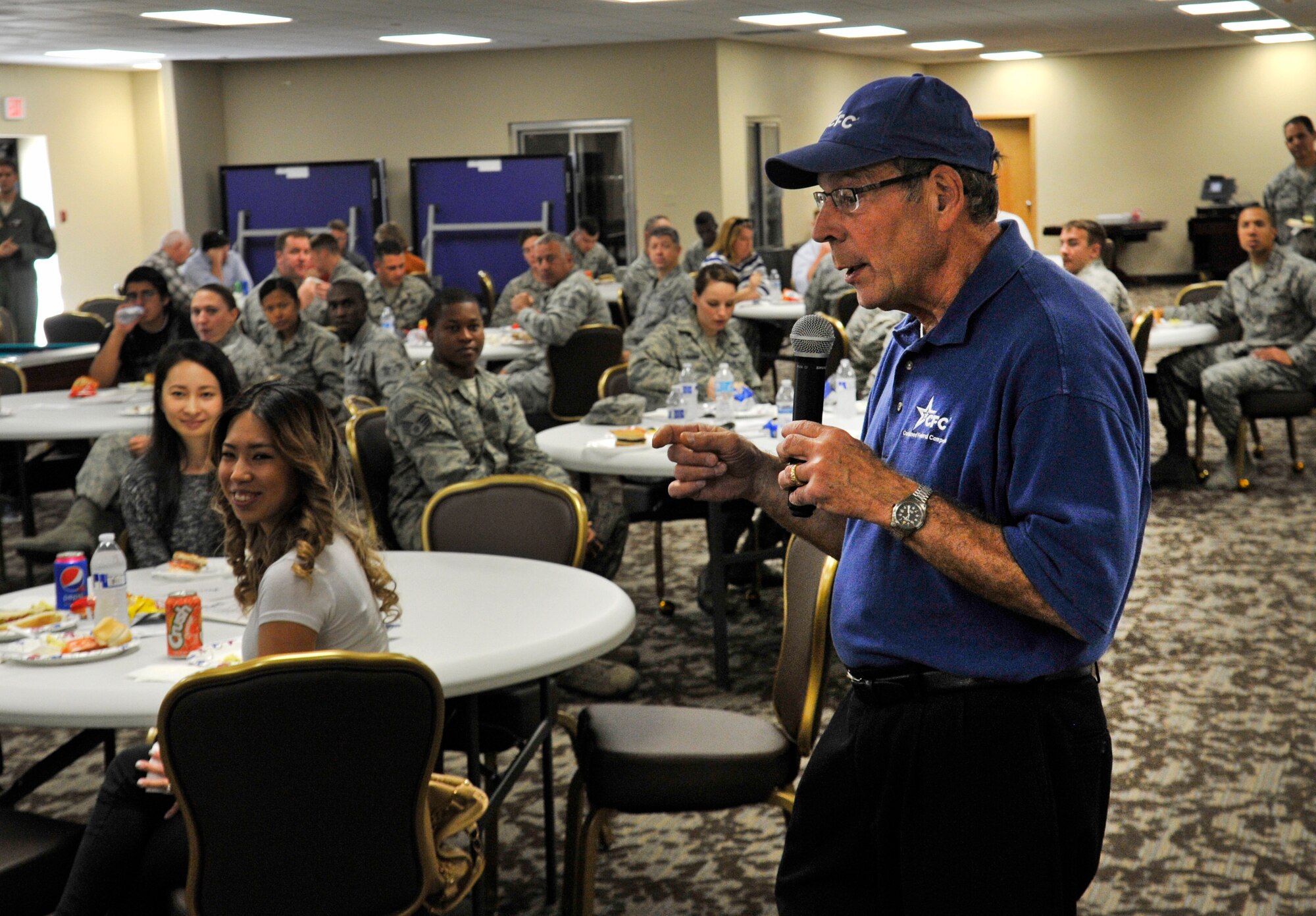John Guilbeault, combined federal campaign manager, speaks on behalf of the CFC and the importance of donating to this campaign in the Red Morgan Center at Fairchild Air Force Base, Wash., Oct. 6, 2014. The Combined Federal Campaign is a program allowing certain nonprofit organizations to solicit contributions from employees of the federal government of the United States. (U.S. Air Force photo by Senior Airman Ryan Zeski)