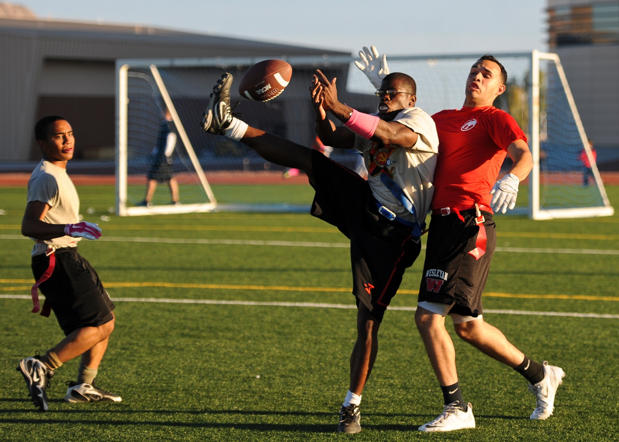 A member of the 757th Aircraft Maintenance Squadron’s Flanker team attempts to grab a pass during a game against the 757th AMXS’ Thunder team at Nellis Air Force Base, Nev., Oct. 6, 2014. This year’s intramural flag football season will feature 23 different teams, the highest amount of teams to participate in 10 years. (U.S. Air Force photo by Airman 1st Class Mikaley Towle)
