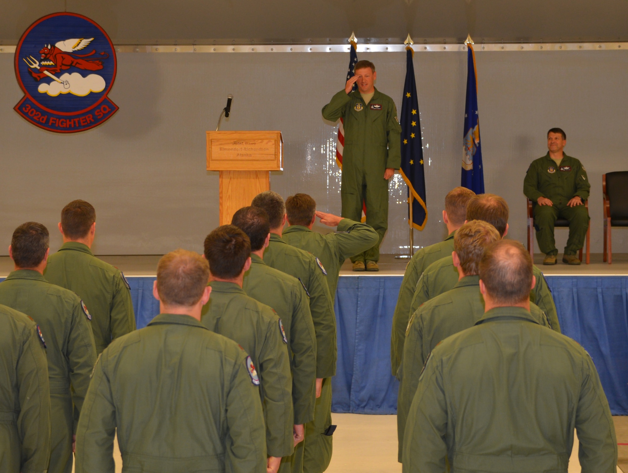 Lt. Col. Christopher Miller, an F-22 pilot from the 302 Fighter Squadron salutes Lt. Col. Kevin Sutterfield for the first time as the newly assigned 302nd FS commander. (Air Force Photo/Tech. Sgt. Dana Rosso)