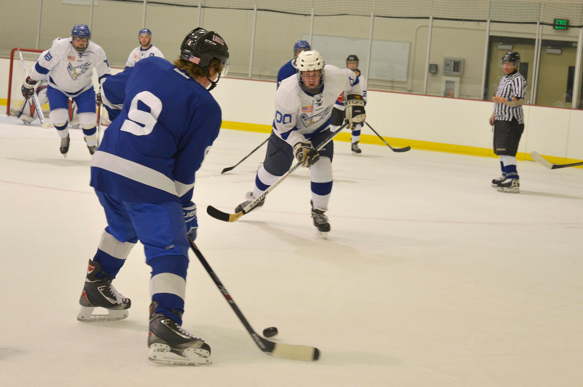 A player from the Blue Team drives down the puck to score a goal during the Blue vs. White Fairchild Falcons Varsity Hockey team game at Eastern Washington University’s Recreation Center in Cheney, Wash., Oct. 4, 2014. The team also participates in the Spokane Hockey League to gain additional experience through scheduled games every week. (U.S. Air Force photo by Airman 1st Class Janelle Patiño)