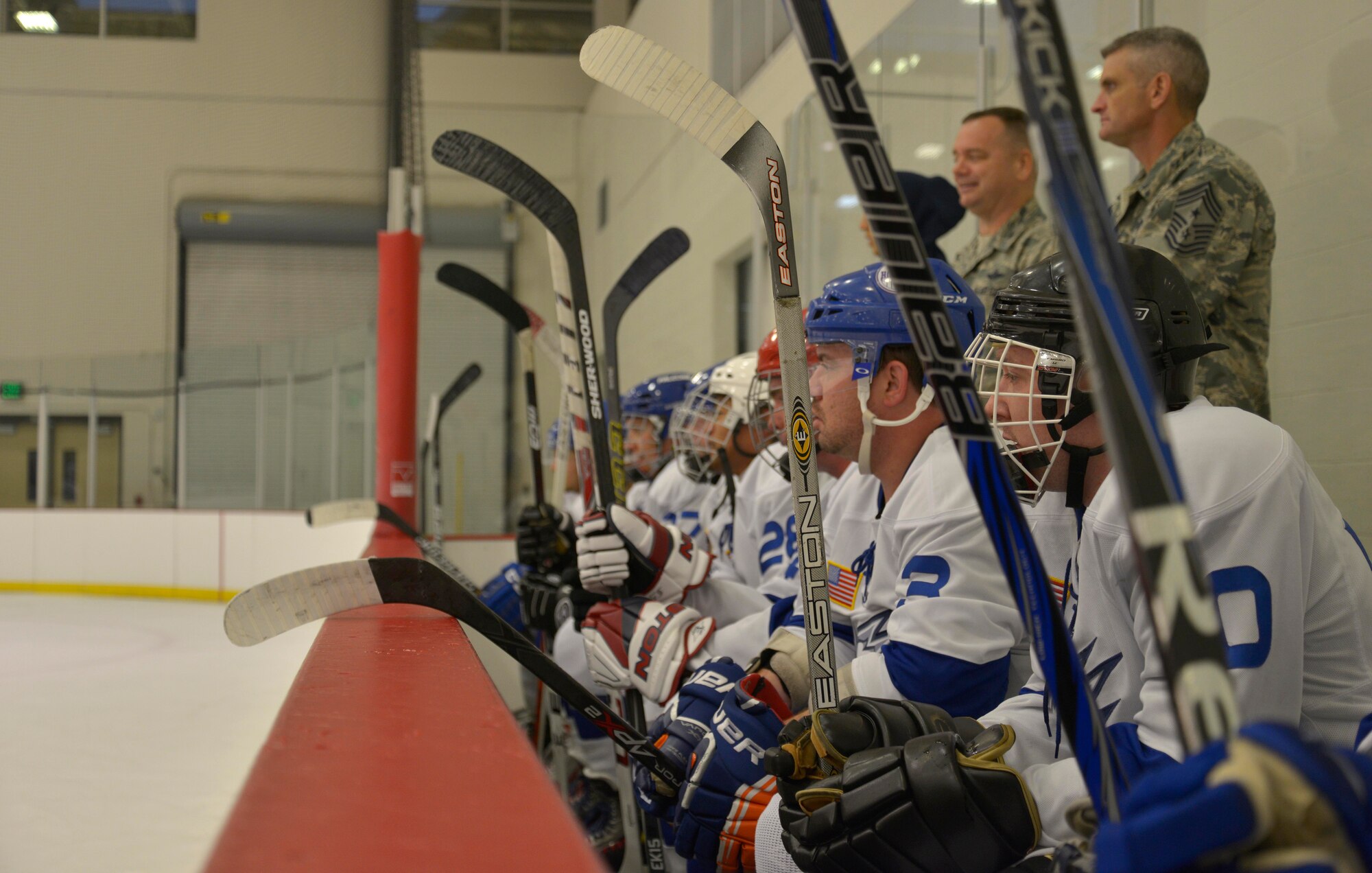 The White team watches as their teammates play during the Blue vs. White Fairchild Falcons Varsity Hockey team game at Eastern Washington University's Recreation Center in Cheney, Wash., Oct. 4, 2014. The Fairchild Air Force Base hockey team was founded in early 2013. (U.S. Air Force photo by Airman 1st Class Janelle Patiño)
