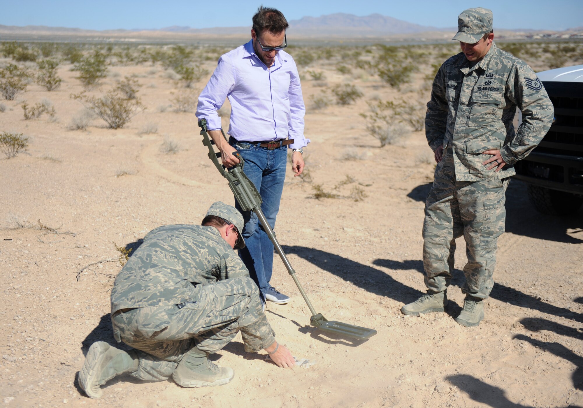Simon Sinek, an internationally renowned speaker and author, uses a metal detector to locate a mine set up by Explosive Ordinance Disposal Airmen at Nellis Air Force Base, Nev., Oct. 1, 2014. Sinek’s visit also included interactions with 99th Security Forces Squadron Military Working Dog handlers and 58th Rescue Squadron members, a visit to the 66th Rescue Squadron to look at the HH-60 Pave Hawk helicopter, and finished with a mission briefing at the Red Flag building. (U.S. Air Force photo by Airman 1st Class Mikaley Towle)