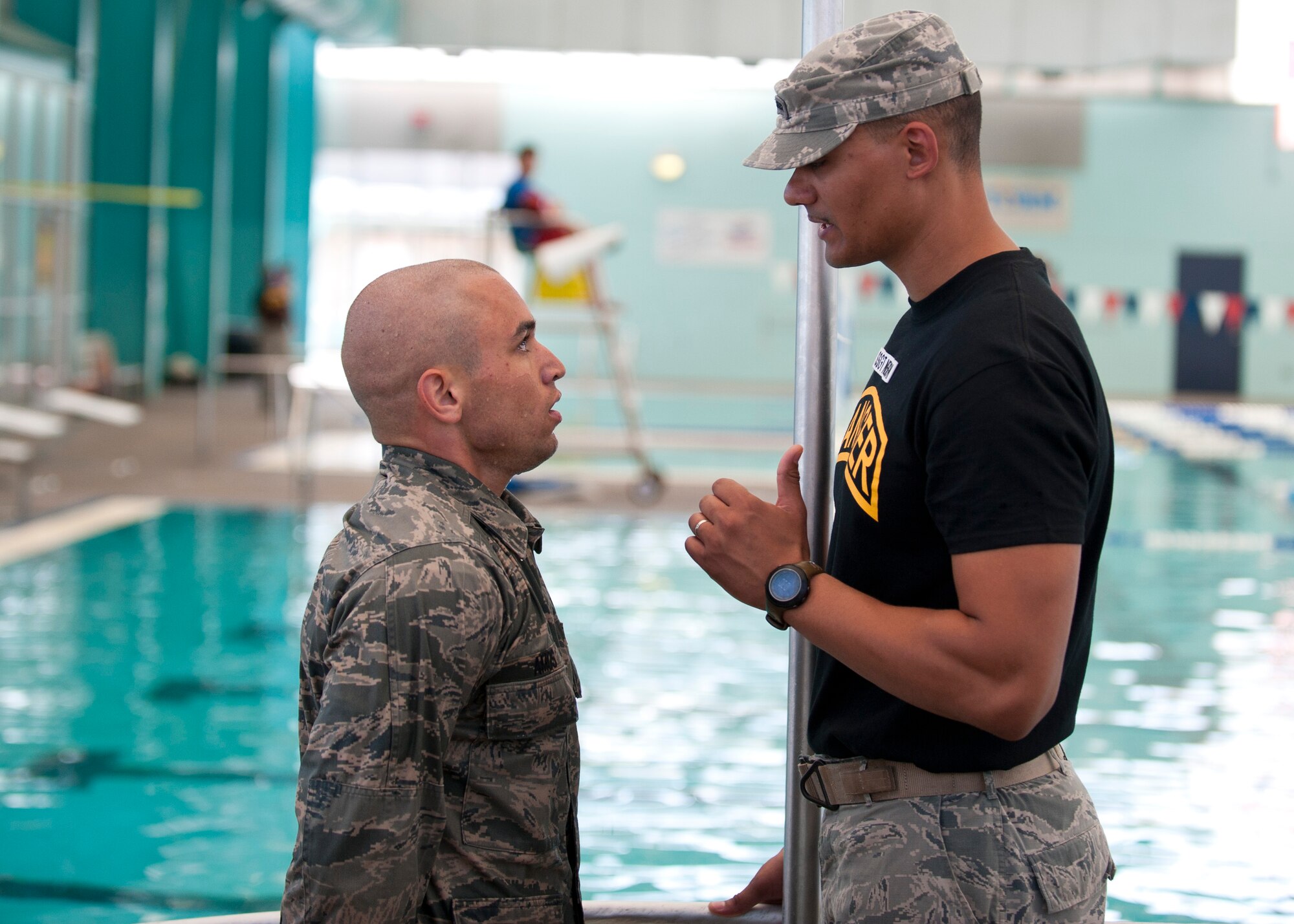 Staff Sgt. Marco Nelson (right), a Ranger Assessment Course instructor, tells a student what he did wrong during the water survival portion of the course at the Municipal Pool, Las Vegas, Oct. 2, 2014. Many students who do not make it through the course underestimate its intensity or fail to do proper research on the course. Every RAC instructor is a U.S. Army Ranger School graduate. (U.S. Air Force photo by Airman 1st Class Thomas Spangler)