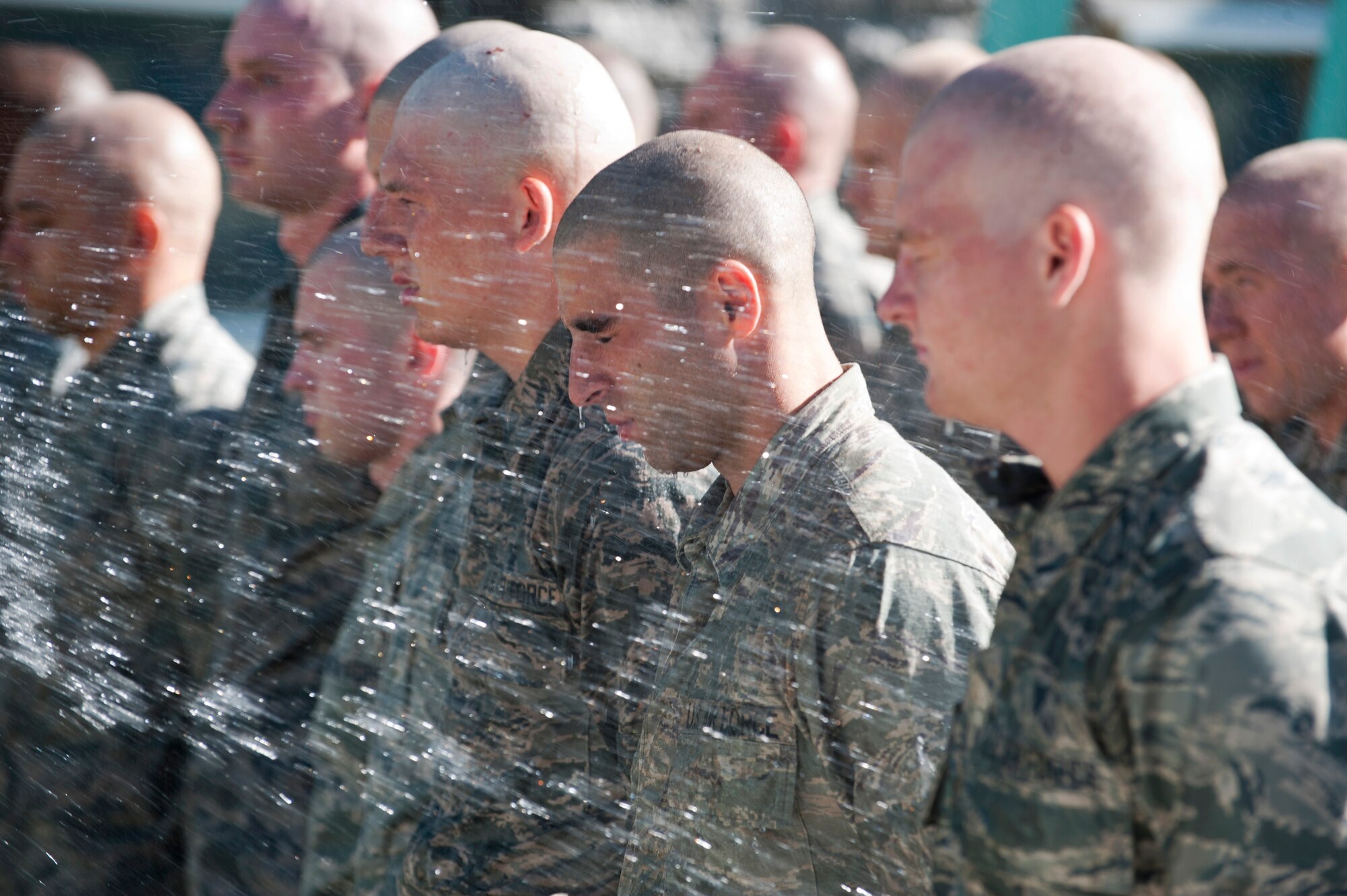 Ranger Assessment Course students are sprayed with a hose at the Municipal Pool, Las Vegas, Oct. 2, 2014. The RAC is meant to assess Airmen to determine if they are strong students for the U.S. Army Ranger School. Many students have difficulty with the course due to the lack of sleep, food, and operating for 22 hours a day all while staying focused on the task at hand. (U.S. Air Force photo by Airman 1st Class Thomas Spangler)