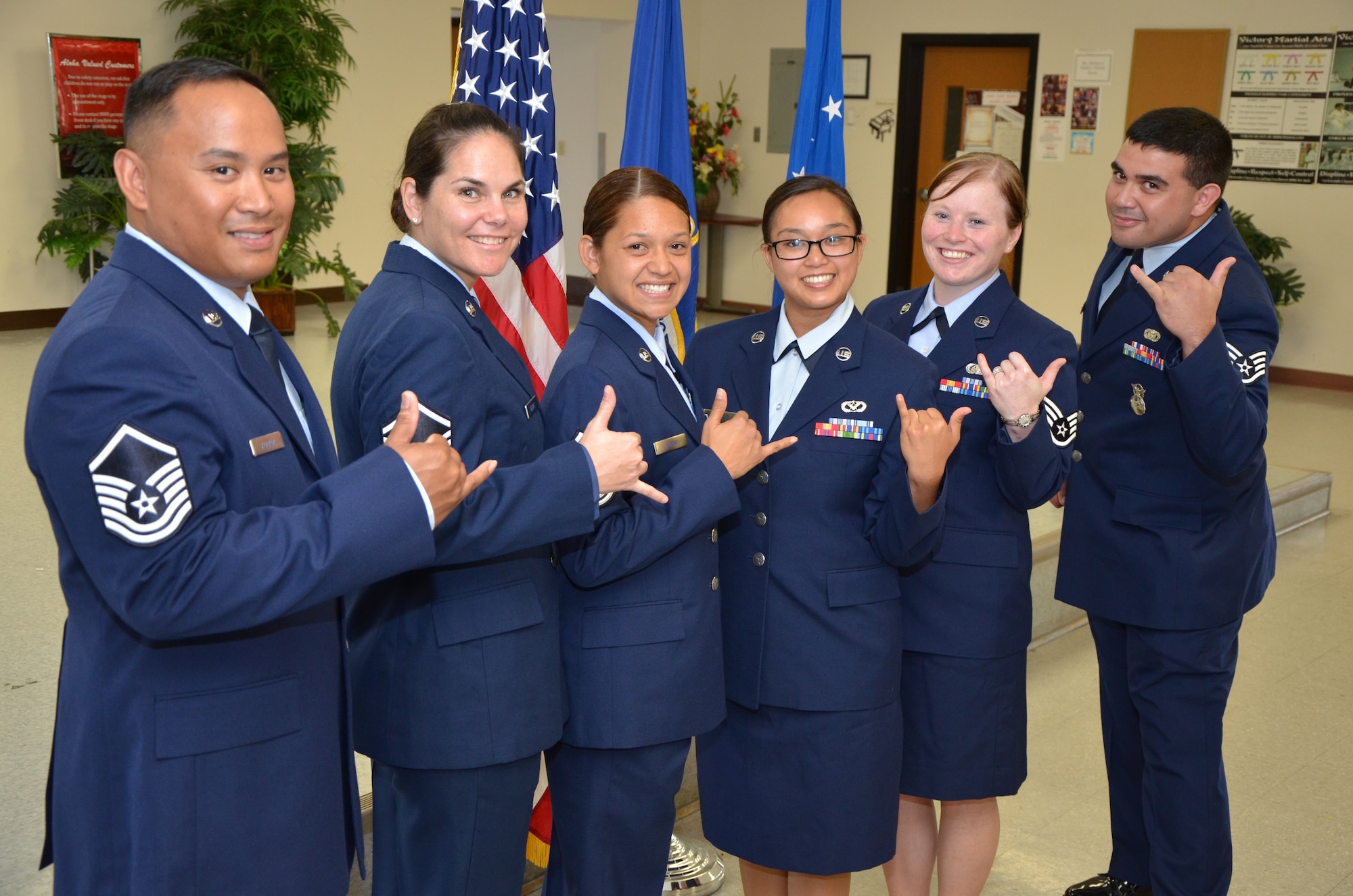 From left, Master Sgt. Roy Agbaoa, an engineering journeyman with the 624th Civil Engineering Squadron; Master Sgt. Elizabeth Andreas Feeney, an air transportation craftsman with the 48th Aerial Port Squadron; Master Sgt. Jahnna Burns, a ramp services craftsman with the 48th APS; Staff Sgt. Tina Corpuz, a pest management journeyman with the 624th CES; Staff Sgt. Anna Frazier, a medical administrative craftsman with the 624th Aeromedical Staging Squadron; and Staff Sgt. Tory Davis, a security forces officer with the 624th Regional Support Group pose for a photo holding up “shakas,” a Hawaiian hand gesture that conveys friendship, understanding and solidarity. The six newly promoted reservists attended an induction ceremony held at the Makai Recreation Center, Hickam Field, Hawaii, Sept. 9, 2014, in honor of their transition to the next levels of leadership. (U.S. Air Force photo by Tech. Sgt. Phyllis Keith)