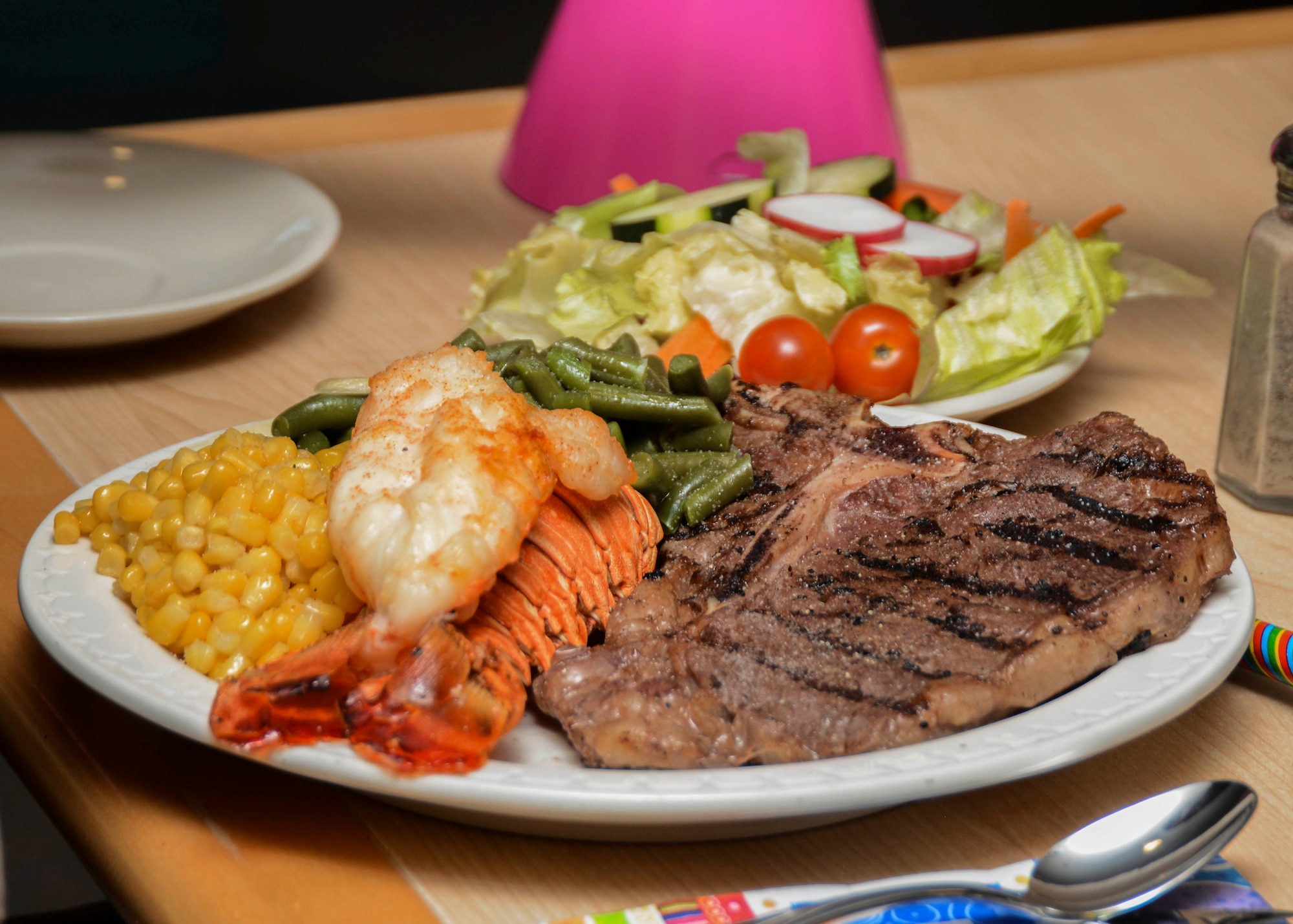 Airmen are served a choice of two entrees: steak, lobster or Dijon glazed chicken. The entrees are paired with a variety of sides during the quarterly birthday meal at the Joshua Tree Dining Facility Oct. 8. (U.S. Air Force photo by Rebecca Amber) 