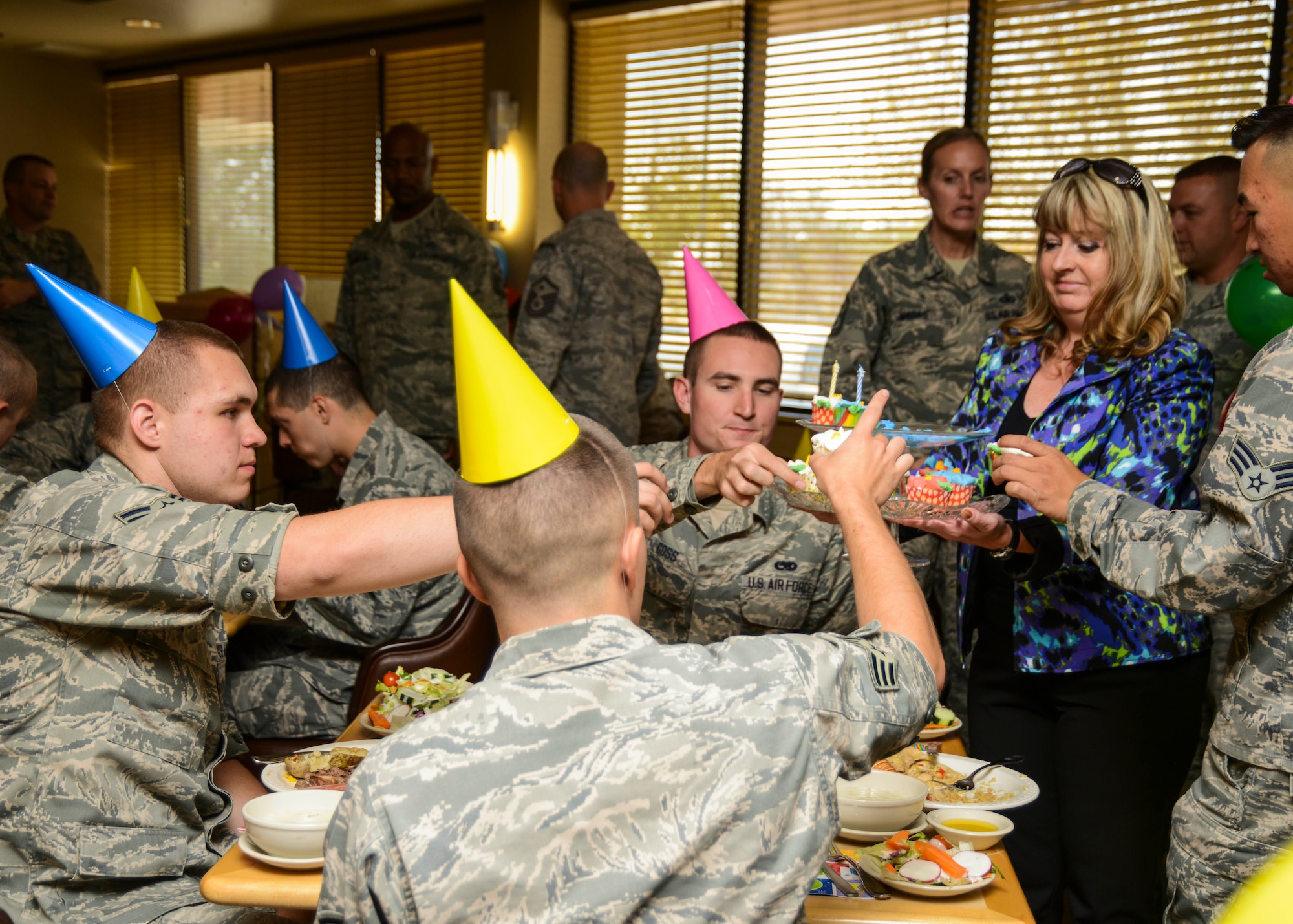 Margaret Fleming (right) 412th Maintenance Squadron director, serves up birthday cupcakes to Airmen at the Joshua Tree Dining Facility Oct. 8. The 412th Force Support Squadron and Team Edwards held its quarterly birthday luncheon for enlisted Airmen who had birthdays in the past quarter. (U.S. Air Force photo by Rebecca Amber) 