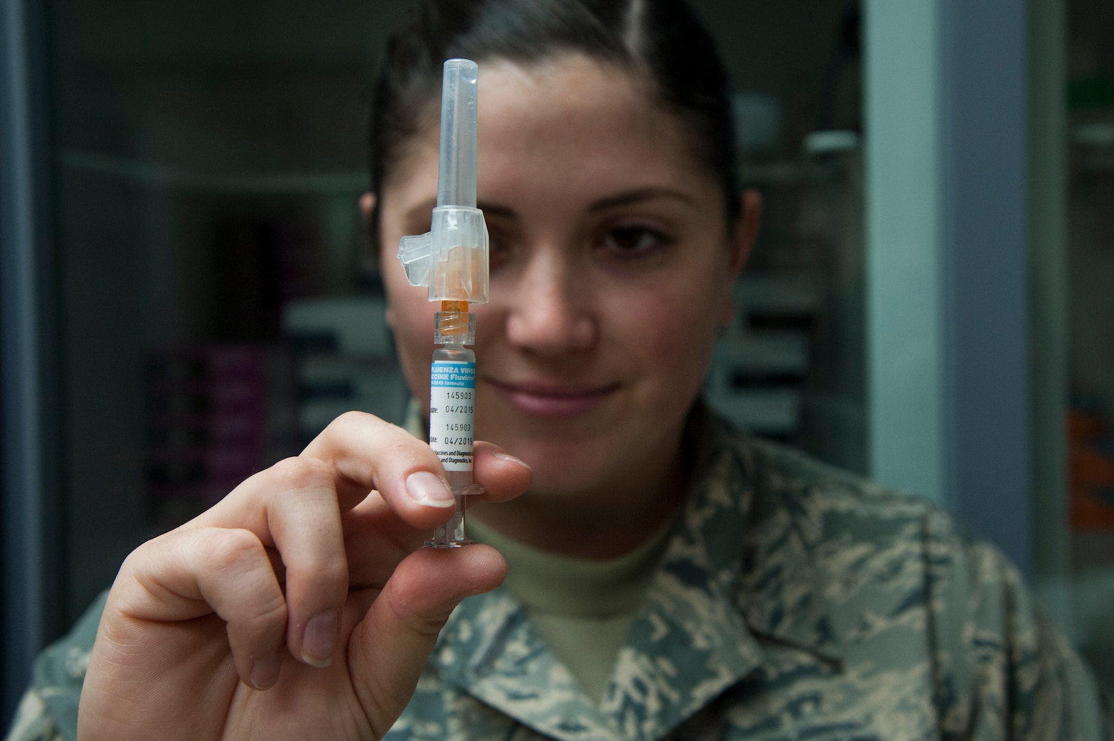 Staff Sgt. Alisha Slone, 359th Medical Group NCO in charge of immunizations, inspects an influenza vaccine Sept. 30, 2014, at the Joint Base San Antonio-Randolph Medical Clinic. The influenza vaccine protects against the main influenza viruses that research suggests will be the most common during that influenza season, according to the Centers for Disease Control and Prevention. (U.S. Air Force photos by Airman 1st Class Stormy Archer/Released)