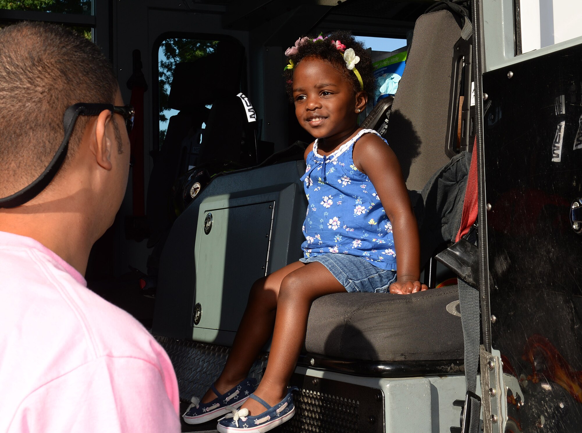 Lyla Beckford, 2, daughter of U.S Navy petty Officer 1st Class Chance Beckford, U.S.S. Enterprise watch commander, sits in a fire truck at the Madison Child Development Center during Fire Prevention Week at Fort Eustis, Va., Oct. 8, 2014. Firefighters offered educational events throughout the week promoting fire safety and prevention. (U.S. Air Force photo by Staff Sgt. Teresa J. Cleveland/Released)