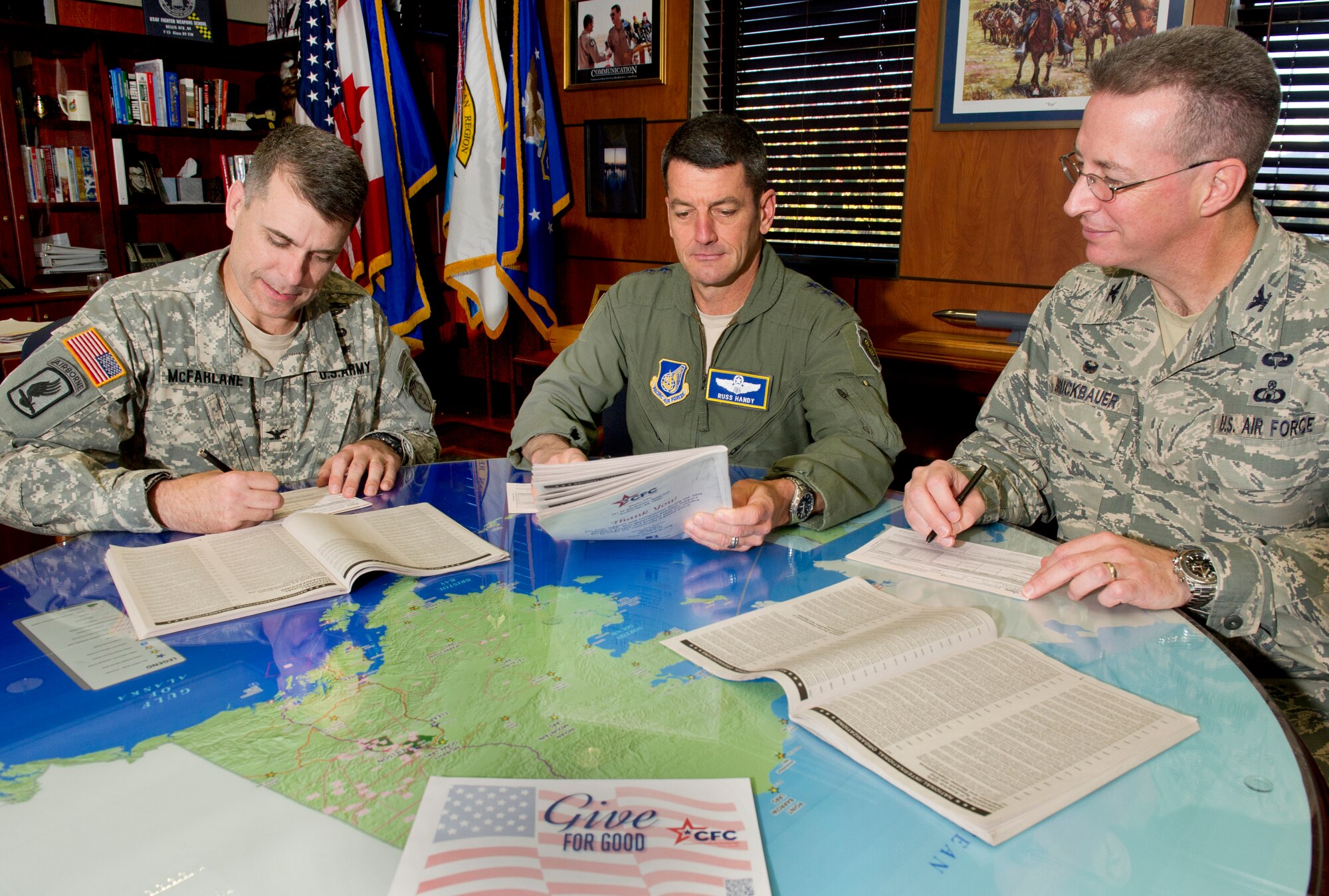 Army Colonel Matt McFarlane, Air Force Lt. Gen. Russell J. Handy,and Air Force Colonel Brian Bruckbauer, make donations to the Combined Federal Campaign, Monday, Oct. 6, 2014, at JBER. Since the CFC was established in 1961, it has provided opportunities for federal employees to give to charities of their choice. McFarlane is the commander of the 4th Infantry Brigade Combat Team (Airborne), 25th Infantry Division, U.S. Army Alaska; Handy is the commander of Alaskan Command, U.S. Pacific Command; commander of Joint Task Force Alaska, U.S. Northern Command; commander of Eleventh Air Force, Pacific Air Forces; and commander, Alaskan Region, North American Aerospace Defense Command; and Bruckbauer is the commander of Joint Base Elmendorf-Richardson, Alaska, and the 673d Air Base Wing.  (U.S. Air Force photo/Justin Connaher) 
