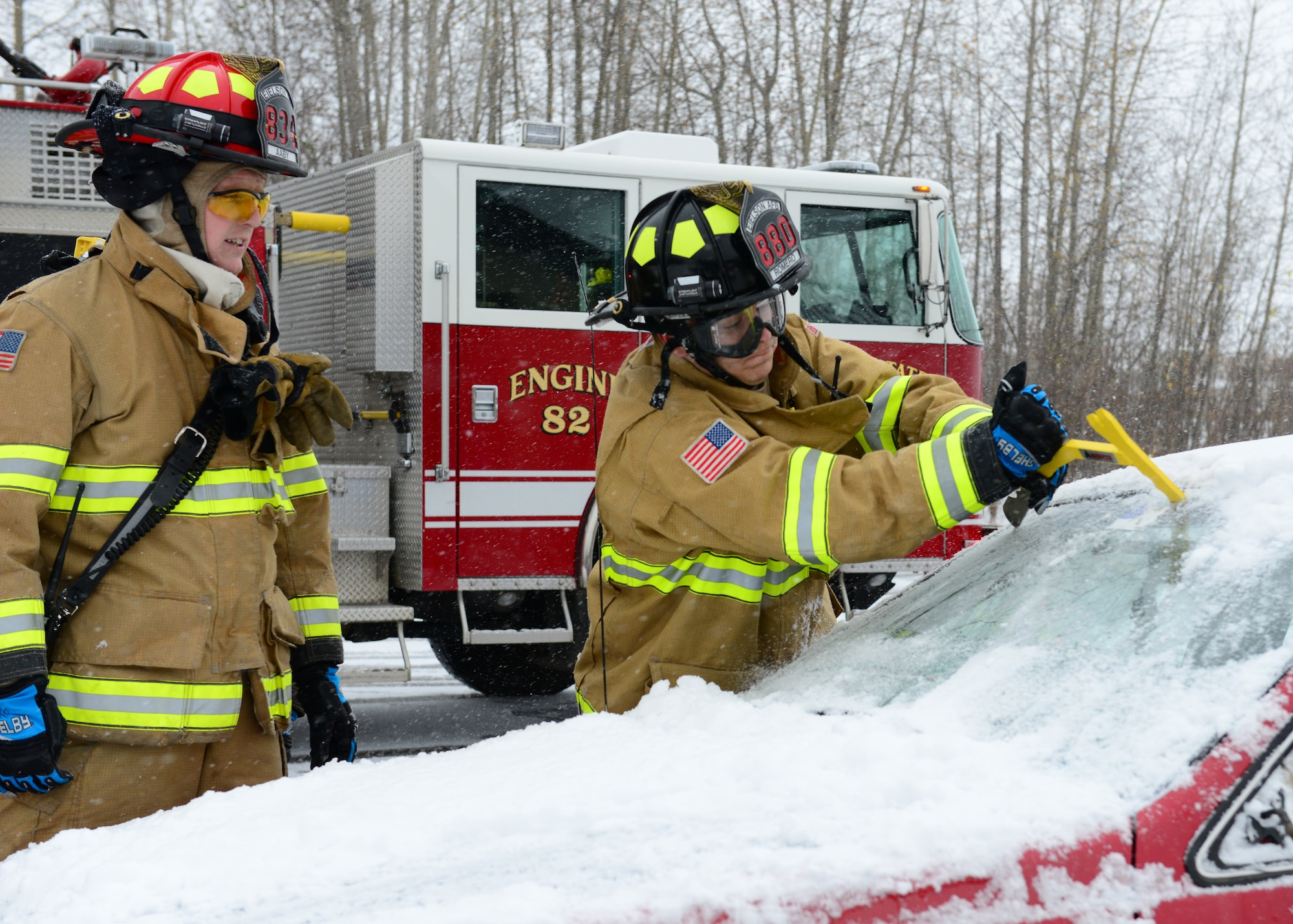 Firefighters assigned to the 354th Civil Engineer Squadron use a window saw during a vehicle extrication demonstration Oct. 5, 2014, Eielson Air Force Base, Alaska. Crowds gathered during the Eielson Fire Department open house to see what is involved during a vehicle extrication and how firefighters gain access to a victim after a crash. (U.S. Air Force photo by Senior Airman Ashley Nicole Taylor/Released)