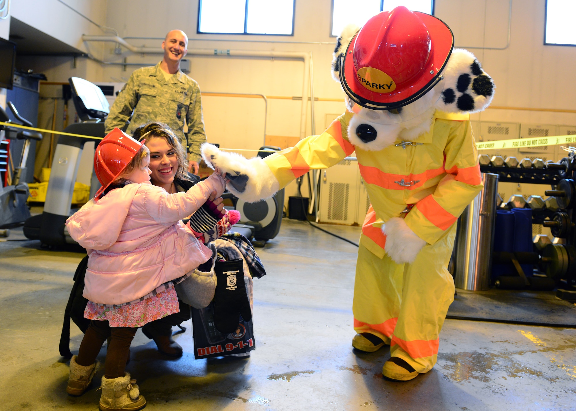 Riley Young gives Sparky the Fire Dog a high-five during the Eielson Fire Department’s open house Oct. 5, 2014, Eielson Air Force Base, Alaska. The open house kicked off Fire Prevention Week with this year’s theme, ‘Working smoke alarms save lives, test yours every month.’ Almost 60 percent of reported home fire deaths in 2007 to 2011 resulted from fires in homes with no smoke alarms or no working smoke alarms. (U.S. Air Force photo by Senior Airman Ashley Nicole Taylor/Released)