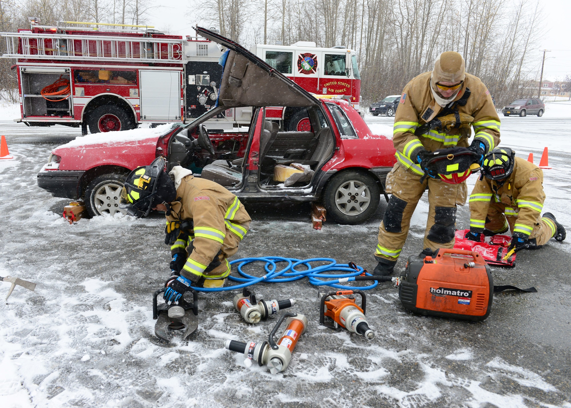 Firefighters assigned to the 354th Civil Engineer Squadron pack up tools after a vehicle extrication demonstration at the Eielson Fire Department open house Oct. 5, 2014, Eielson Air Force Base, Alaska. Tools such as the Jaws of Life, a window punch and a window saw are all used during a vehicle extrication to gain access to crash victims by the safest and quickest means possible. (U.S. Air Force photo by Senior Airman Ashley Nicole Taylor/Released)