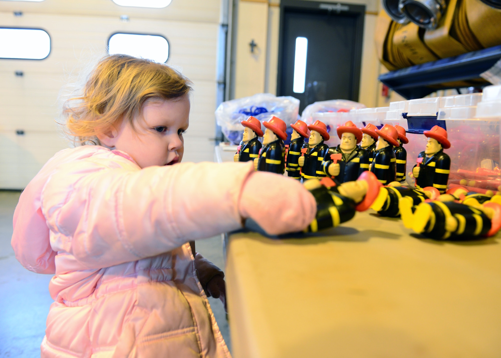 Riley Young checks out a table of promotional items at the Eielson Fire Department’s open house Oct. 5, 2014, Eielson Air Force Base, Alaska. Icemen firefighters planned the first open house in ten years to kick off Fire Prevention Week. (U.S. Air Force photo by Senior Airman Ashley Nicole Taylor/Released)