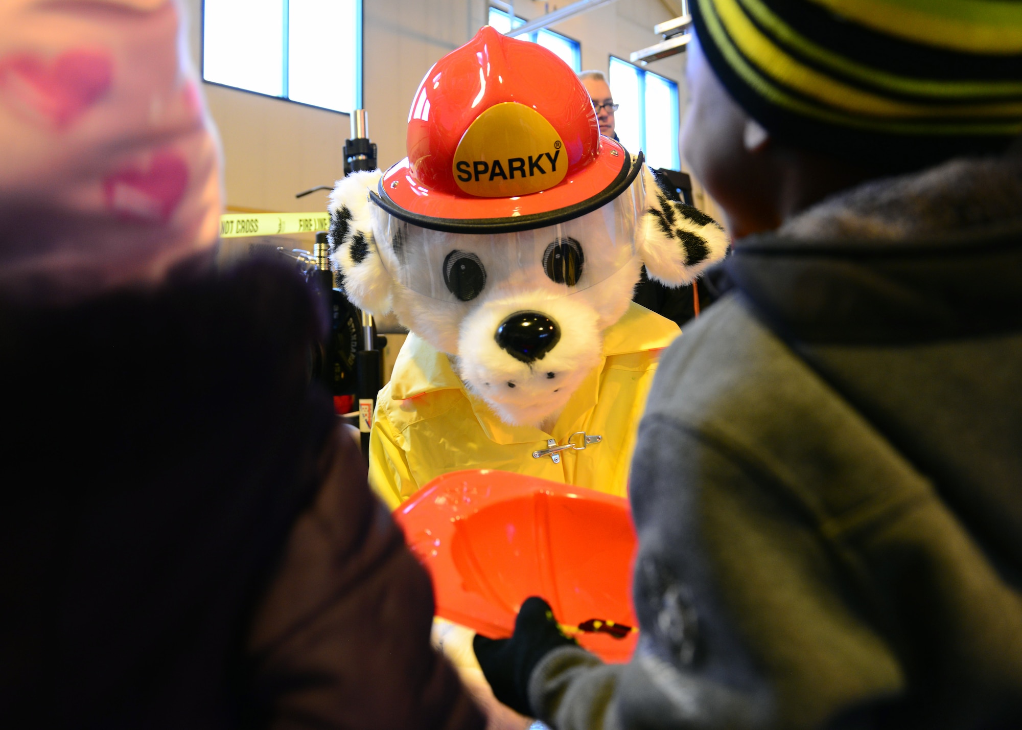 Sparky the Fire Dog interacts with children attending the Eielson Fire Department open house Oct. 5, 2014, Eielson Air Force Base, Alaska. The open house kicked off Fire Prevention Week with this year’s theme, ‘Working smoke alarms save lives, test yours every month.’ (U.S. Air Force photo by Senior Airman Ashley Nicole Taylor/Released)