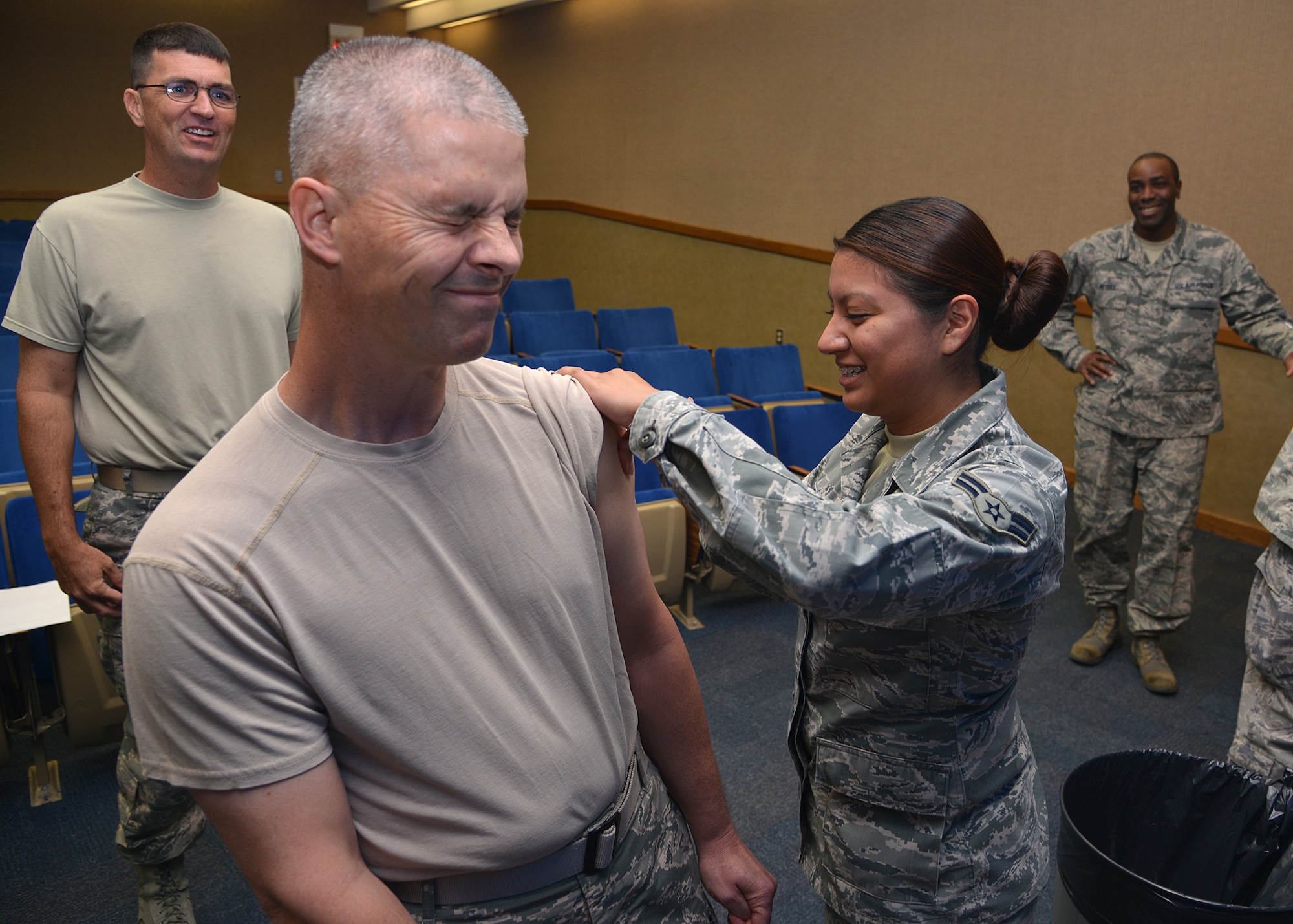 Chief Master Sgt. John Dougherty, 377th Air Base Wing command chief, gets a flu shot from Airman 1st Class Jennifer Pacheco, a medical technician in the 377th Medical Group. The flu vaccine is now availble for active duty and TRICARE eligible beneficiaries. (Photo by Todd Berenger)