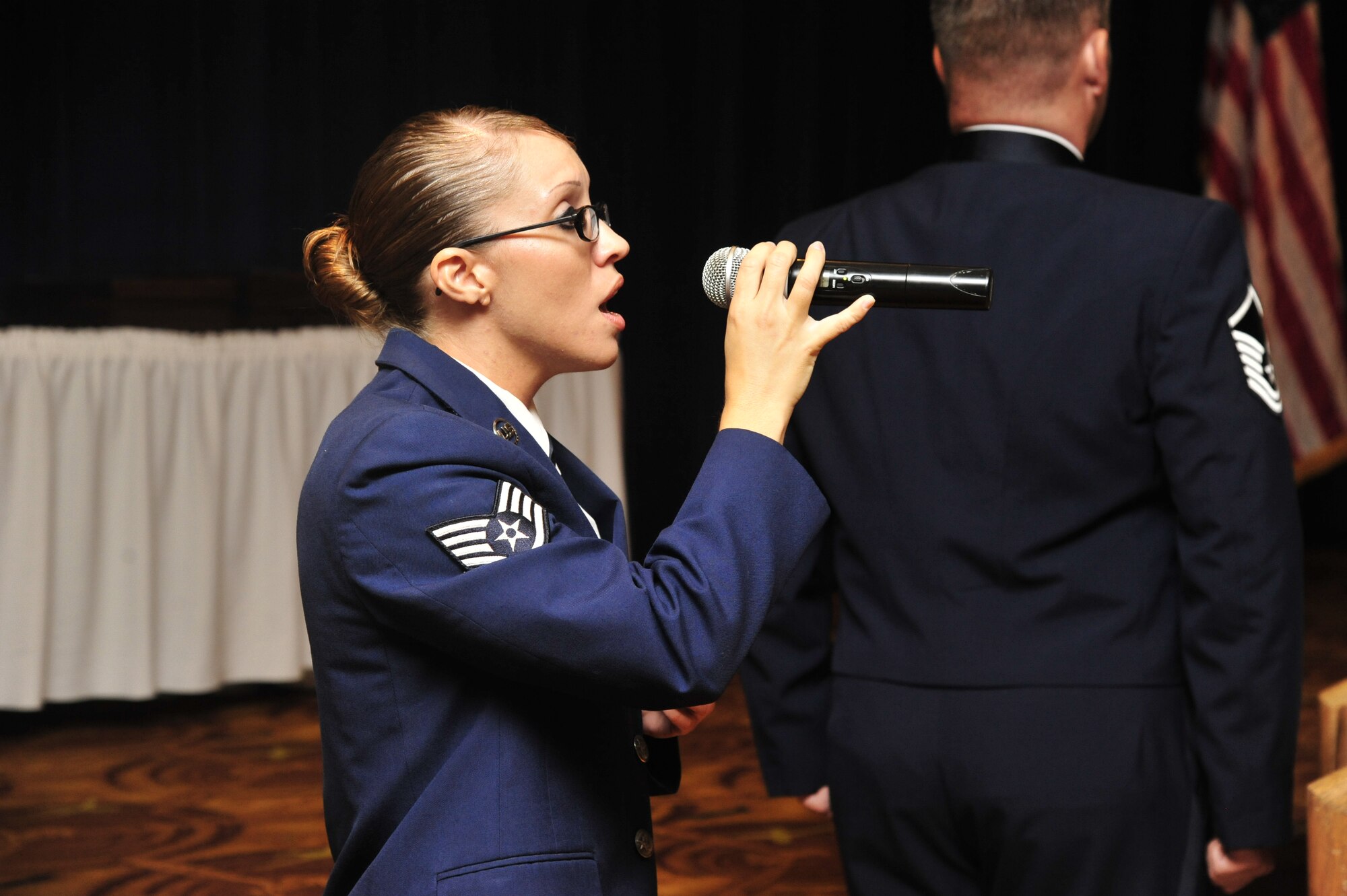 Staff Sgt. Samantha Renner, 56th Logistics Readiness Squadron fuels distribution supervisor, sings the National Anthem at the Senior NCO Induction Ceremony in Club Five Six at Luke Air Force Base. Renner has been singing the National Anthem at Luke for the past eight years. (U.S. Air Force photo/Senior Airman Grace Lee)