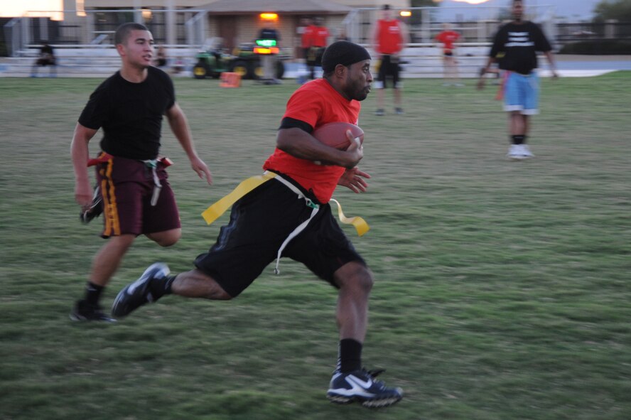 TaRue Broady, 56th Medical Group quarterback, runs the ball during a matchup Sept. 22 against Airmen from the 56th Communications Squadron at Luke Air Force Base. With completions and good defense MDG won the match 34-13. (U.S. Air Force photo/Airman 1st Class James Hensley)