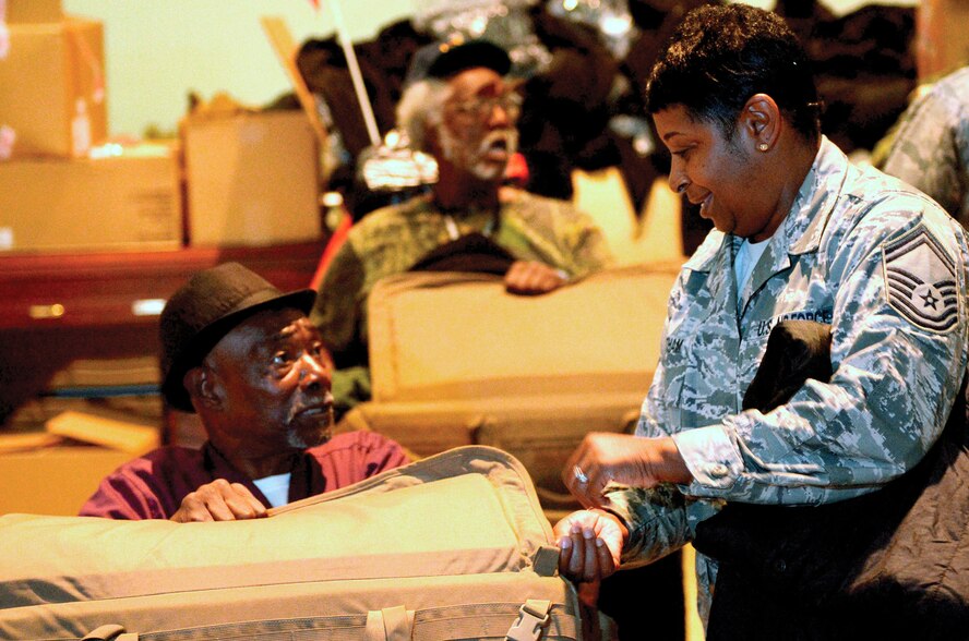 WRIGHT-PATTERSON AIR FORCE BASE, Ohio - Senior Master Sgt. Patricia Wortham, 445th Force Support Squadron, assists a local veteran during the Dayton Veterans Affairs Medical Center Homeless Vets Stand Down, Sept. 5, 2014. A dozen members from the wing volunteered to support the event by sorting and handing out clothing and other items to more than 150 homeless vets. (U.S. Air Force photo/Senior Airman Devin Long)