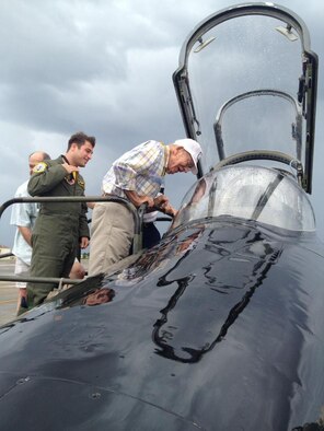 A current member of the 325th Fighter Wing Checkertails shows a World War II-era veteran of the 325th Fighter Group a T-38 Talon, which the wing uses to fly as aggressors against F-22 Raptor pilots. The 69th Annual Reunion of the 325th FG “Checkertail Clan” was held Sept. 25-28 in Tampa Bay, Fla., with three members of modern-day Checkertails sharing stories with more than 40 attendees. 