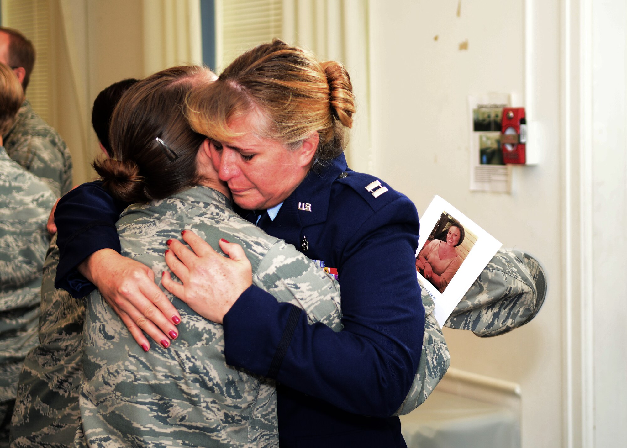 U.S. Air Force Capt. Paula Sauer, USAF Hospital Langley birthing center element leader, hugs 1st Lt. Lauren Hess, USAF Hospital Langley birthing center clinical nurse, in the Chapel Annex at Langley Air Force Base, Va., Oct. 3, 2014. Sauer and Hess attended the memorial service of Capt. Kendra Balcom, who passed away Sept. 20. (U.S. Air Force photo by Airman 1st Class Devin Scott Michaels/Released)