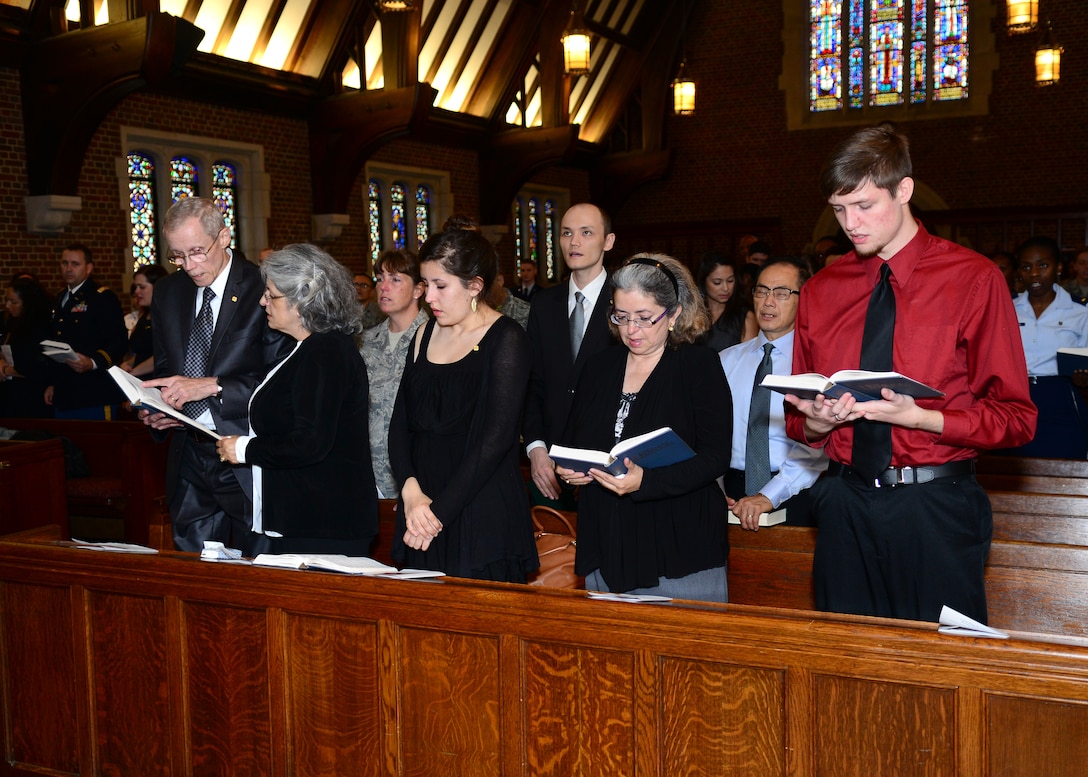 Family and friends of the late U.S. Air Force Capt. Kendra Balcom sing hymns at a memorial service in the Chapel at Langley Air Force Base, Va., Oct. 3, 2014. Balcom’s burial will include full military honors at Arlington National Cemetery. (U.S. Air Force photo by Airman 1st Class Devin Scott Michaels/Released)