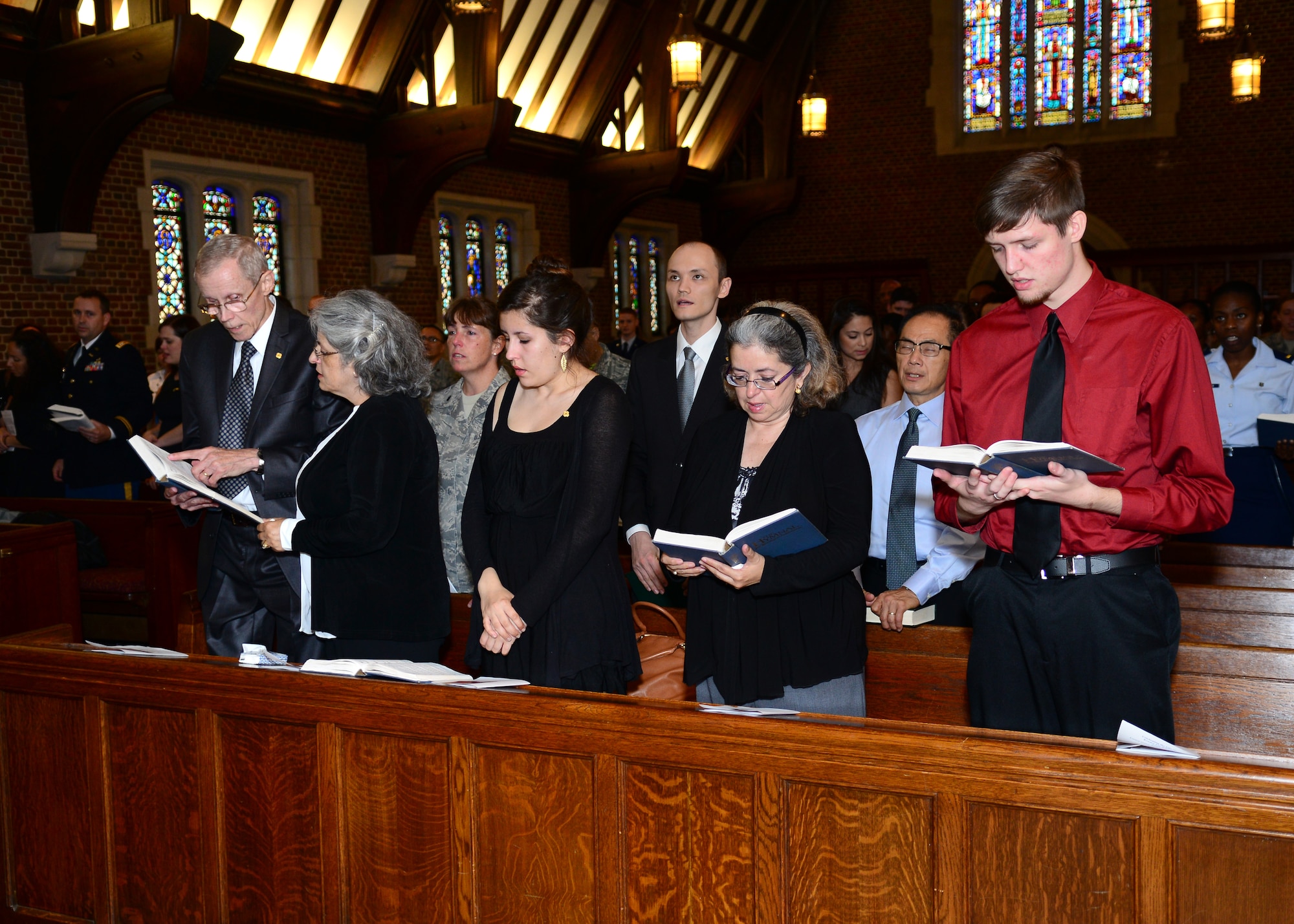 Family and friends of the late U.S. Air Force Capt. Kendra Balcom sing hymns at a memorial service in the Chapel at Langley Air Force Base, Va., Oct. 3, 2014. Balcom’s burial will include full military honors at Arlington National Cemetery. (U.S. Air Force photo by Airman 1st Class Devin Scott Michaels/Released)