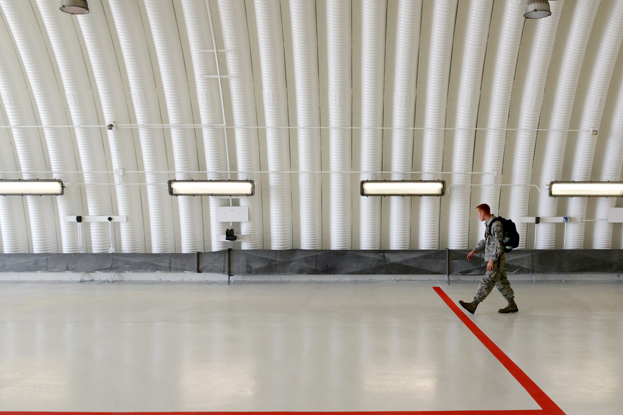 Airman 1st Class Matthew Galati, 31st Aircraft Maintenance Squadron crew chief, inspects a protective aircraft shelter for foreign objects debris, Oct. 7, 2014, at Aviano Air Base, Italy. During a FOD inspection, a crew chief looks for anything that could potentially damage an aircraft upon starting the engine. (U.S. Air Force photo/Airman 1st Class Ryan Conroy) 