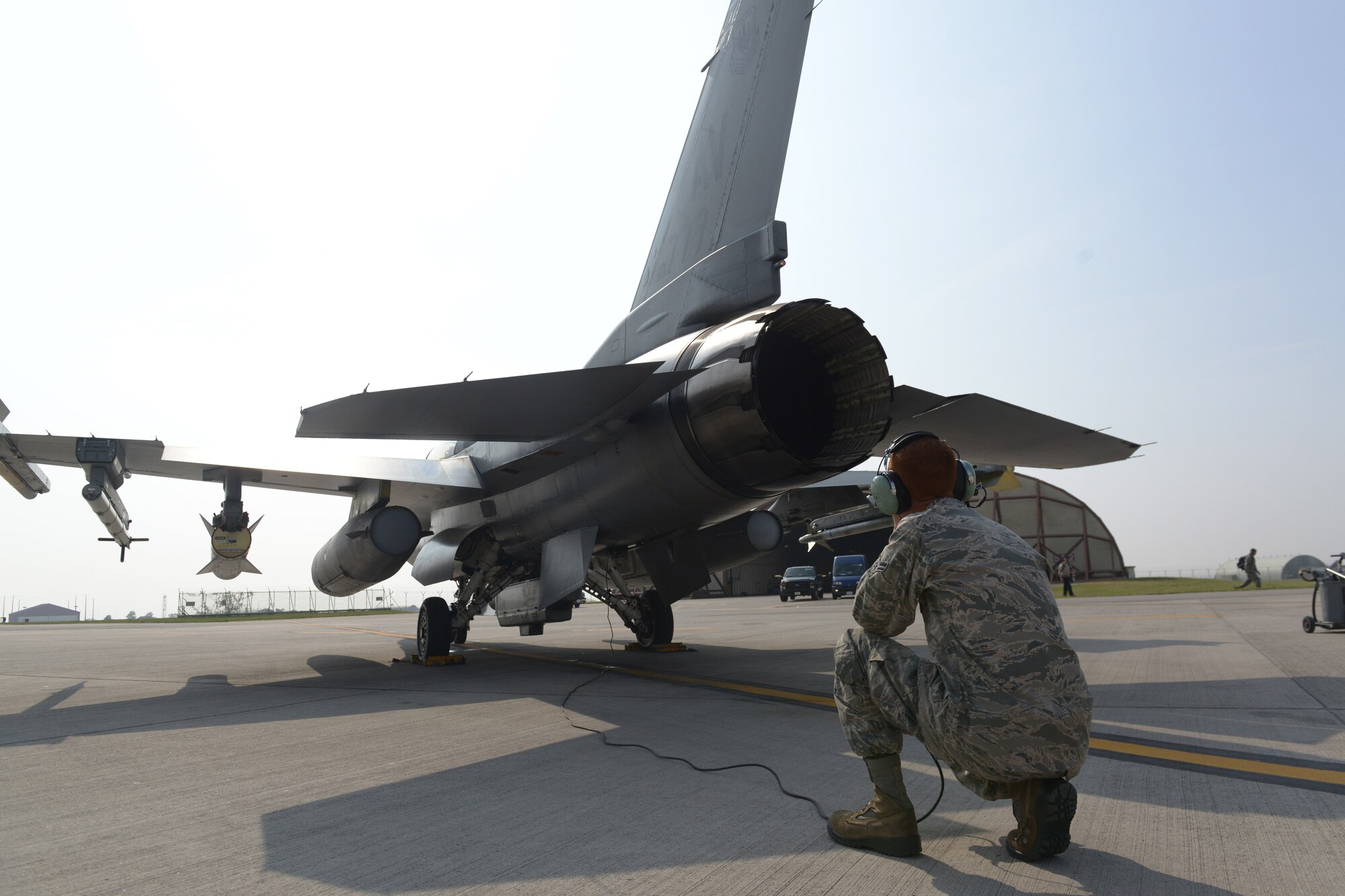 Airman 1st Class Matthew Galati, 31st Aircraft Maintenance Squadron crew chief, crouches down during an inspection of an F-16 Fighting Falcon’s wing flaps, Oct. 7, 2014, at Aviano Air Base, Italy. Crew chiefs meticulously inspect a jet for any mechanical problems before a pilot takes flight. (U.S. Air Force photo/Airman 1st Class Ryan Conroy) 