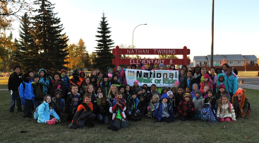 Children of Grand Forks Air Force Base, N.D., brave the brisk morning air to participate in National Walk or Ride to School Day Oct. 8, 2014. National Walk or Ride to School Day was established to promote physical activity and street safety to young children. Children are encouraged to walk to school or ride their bike with adult supervision to learn these important lessons. (U.S. Air Force photo/Airman 1st Class Bonnie Grantham)
