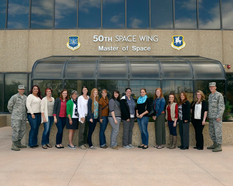 Col. Bill Liquori (left), 50th Space Wing commander, and Col. Brian Barthel (right), 50th Mission Support Group commander, pose for a photo with spouses as part of Heartlink Oct. 1, 2012, at Schriever Air Force Base, Colo. Heartlink is a spouse orientation that aims to provide base and Air Force information to Schriever spouses. The program also highlights how important spouses are to Team Schriever. (U.S. Air Force photo/Christopher DeWitt)