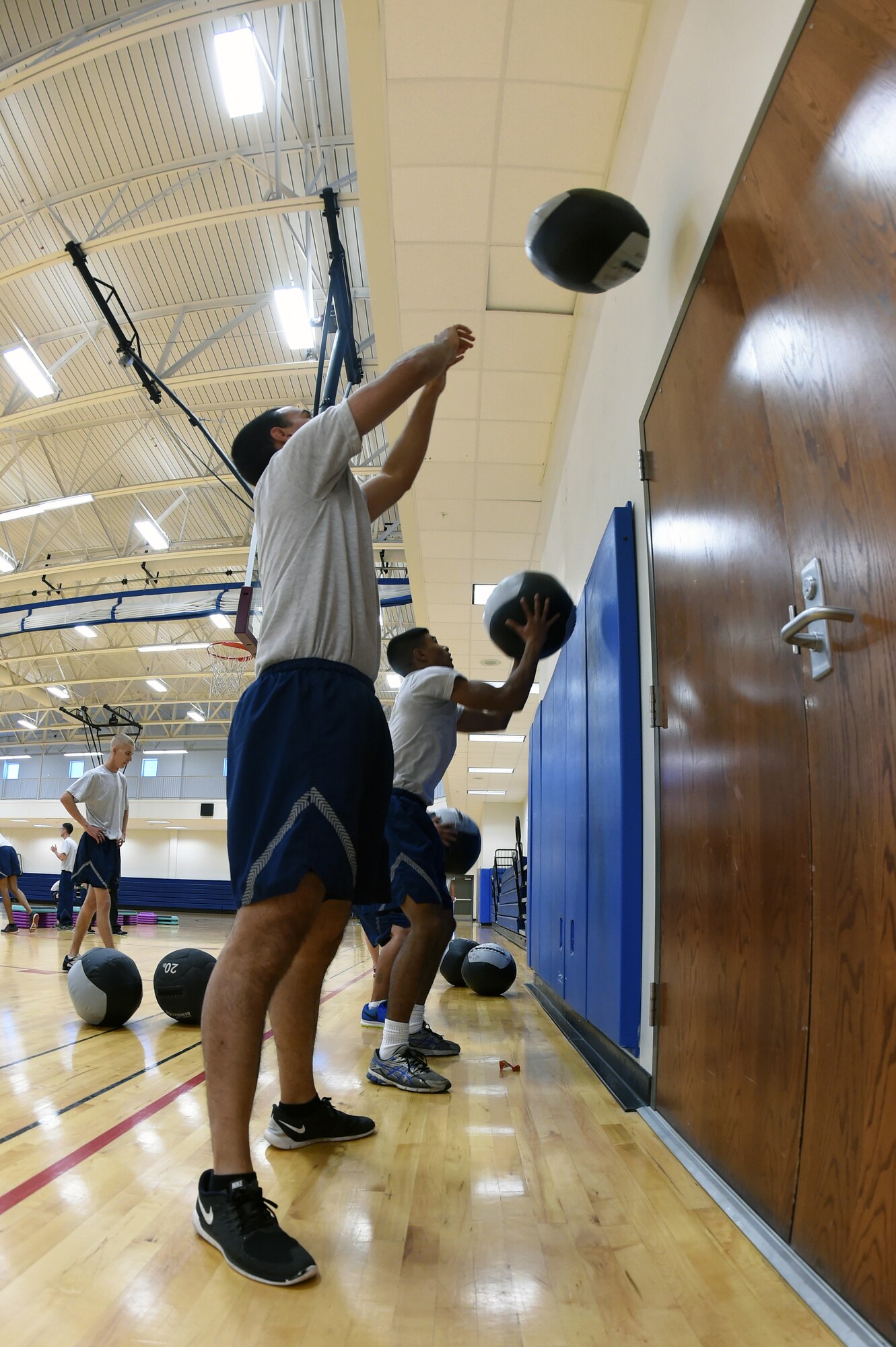 Team Buckley members toss wall-balls during Chief Master Sgt. Craig S. Hall’s, 460th Space Wing command chief, last “Chief’s Workout” Oct. 7, 2014, at the fitness center on Buckley Air Force Base, Colo., before he leaves for his next duty station. The workout provided volunteers from different units an hour-long exercise session once a month that consisted of cardio and strength training exercises, as well as time with their command chief. (U.S. Air Force photo by Airman 1st Class Samantha Saulsbury/Released)