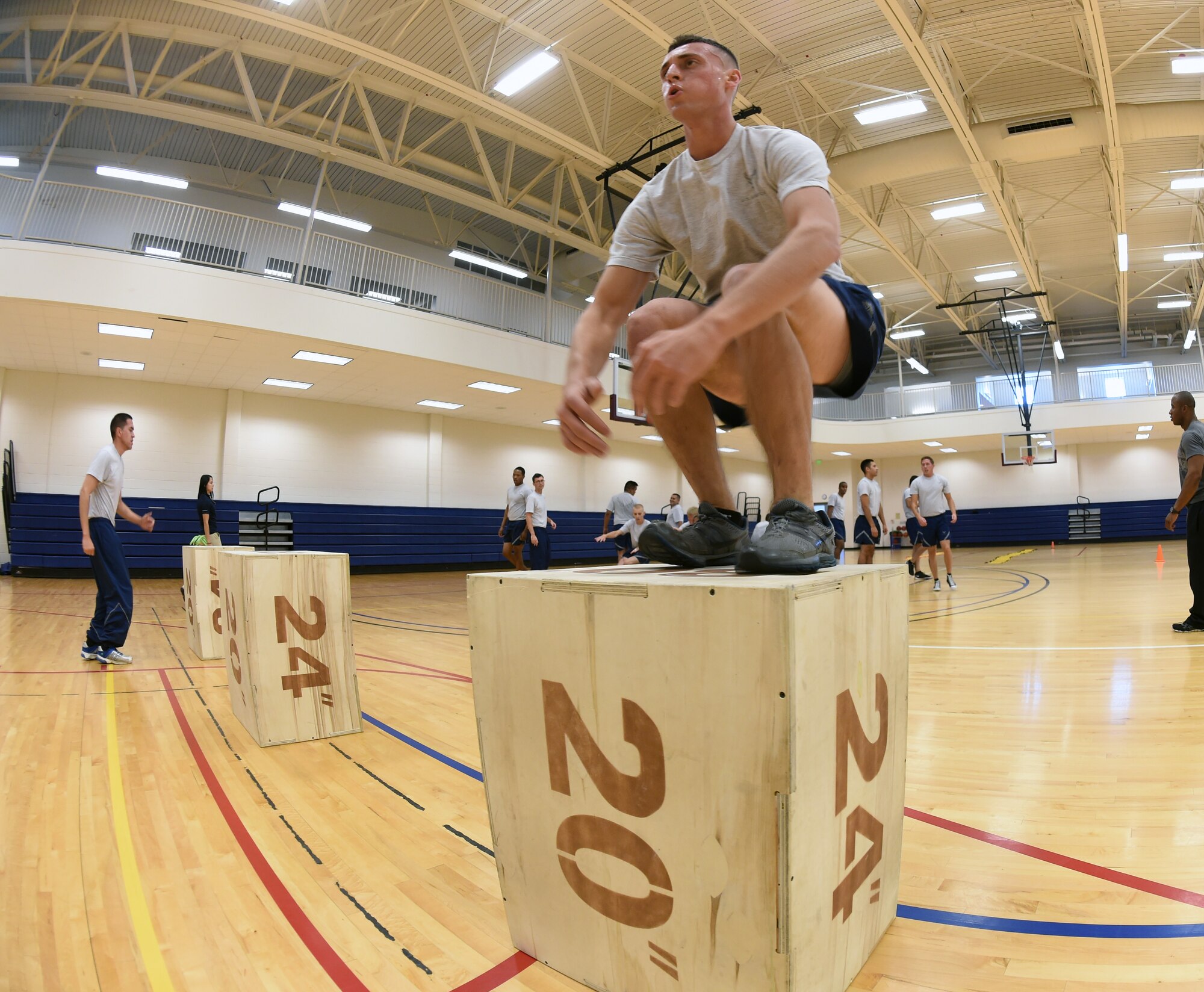 Airman 1st Class John Moody, 460th Space Communications Squadron wing information assurance officer, does box jumps during “Chief’s Workout” Oct. 7, 2014, at the fitness center on Buckley Air Force Base, Colo. The workout provided volunteers from different units an hour-long exercise session that consisted of cardio and strength training exercises, as well as time with Chief Master Sgt. Craig S. Hall, 460th Space Wing Command Chief. (U.S. Air Force photo by Airman 1st Class Samantha Saulsbury/Released)