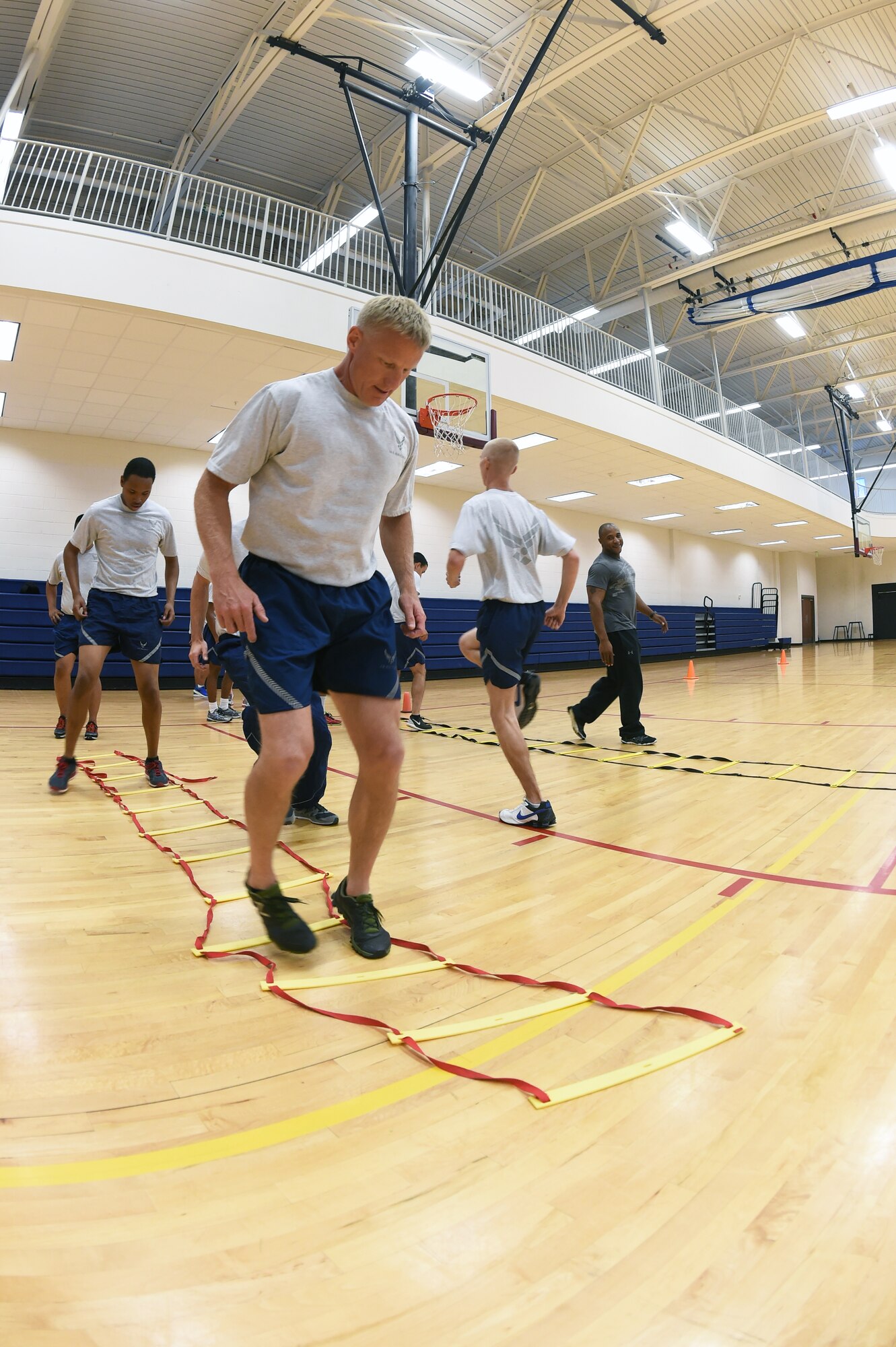 Chief Master Sgt. Craig S. Hall, 460th Space Wing command chief, participates in his last “Chief’s Workout” Oct. 7, 2014, at the fitness center on Buckley Air Force Base, Colo., before he leaves for his next duty station. The workout provided volunteers from different units an hour-long exercise session once a month that consisted of cardio and strength training exercises, as well as time with their command chief. (U.S. Air Force photo by Airman 1st Class Samantha Saulsbury/Released)
