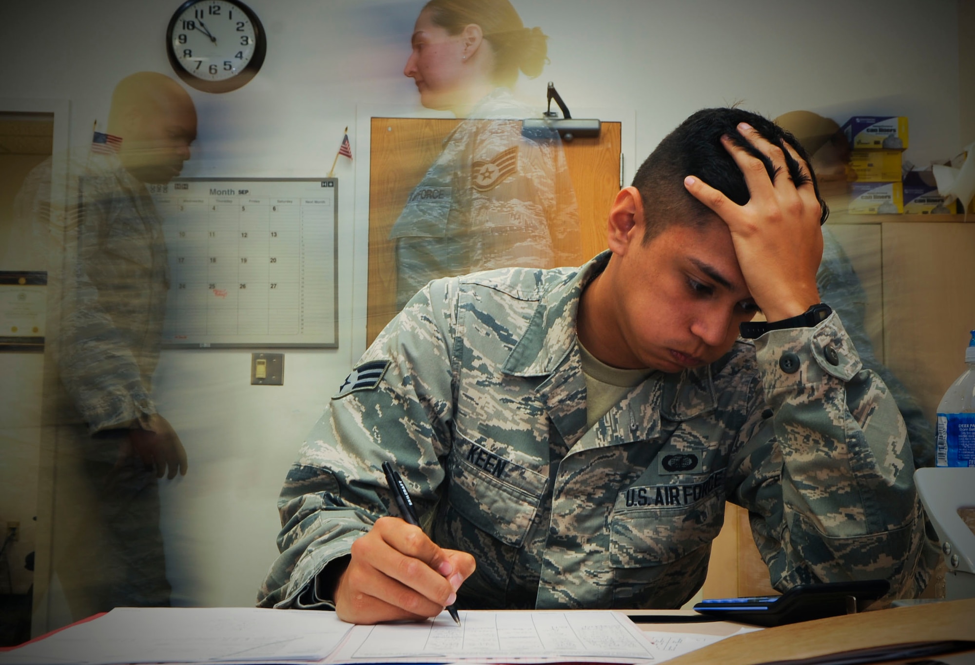 U.S. Air Force Senior Airman Ron Keen, 633rd Comptroller Squadron budget analyst, processes paperwork at Langley Air Force Base, Va., Sept. 24, 2014. During most of September, personnel at the 633rd Contracting and Comptroller Squadrons work 10 to 12 hours every day due to the end of the fiscal year. Both squadrons process purchase requests, moving millions of dollars in assets and funds before the Oct. 1 deadline. (U.S. Air Force graphic by Senior Airman Austin Harvill/Released)
