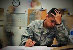 U.S. Air Force Senior Airman Ron Keen, 633rd Comptroller Squadron budget analyst, processes paperwork at Langley Air Force Base, Va., Sept. 24, 2014. During most of September, personnel at the 633rd Contracting and Comptroller Squadrons work 10 to 12 hours every day due to the end of the fiscal year. Both squadrons process purchase requests, moving millions of dollars in assets and funds before the Oct. 1 deadline. (U.S. Air Force graphic by Senior Airman Austin Harvill/Released)