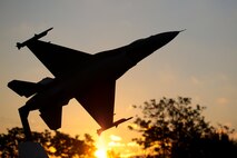 A model of a U.S. Air Force F-16C Fighting Falcon is silhouetted against the sunrise as seen from Atlantic City Air National Guard Base, N.J., home of the New Jersey Air National Guard's 177th Fighter Wing "Jersey Devils," on Oct. 8, 2014. (U.S. Air National Guard photo by Tech. Sgt. Matt Hecht/Released)