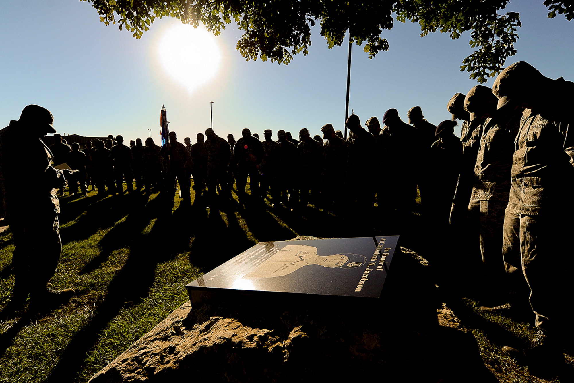 GOODFELLOW AIR FORCE BASE, Texas – Goodfellow members gather around the Airman 1st Class Elizabeth Jacobson Memorial outside the 17th Security Forces building for the opening prayer during the 8th Annual Airman 1st Class Jacobson 4.1-Mile Memorial Ruck March Oct. 4. The ruck march is hosted each year in honor of Jacobson who was the first female Airman to give their life in Operation Iraqi Freedom, as well as the first security forces member killed in combat since 1975. (Air Force photo/ Airman 1st Class Devin Boyer)