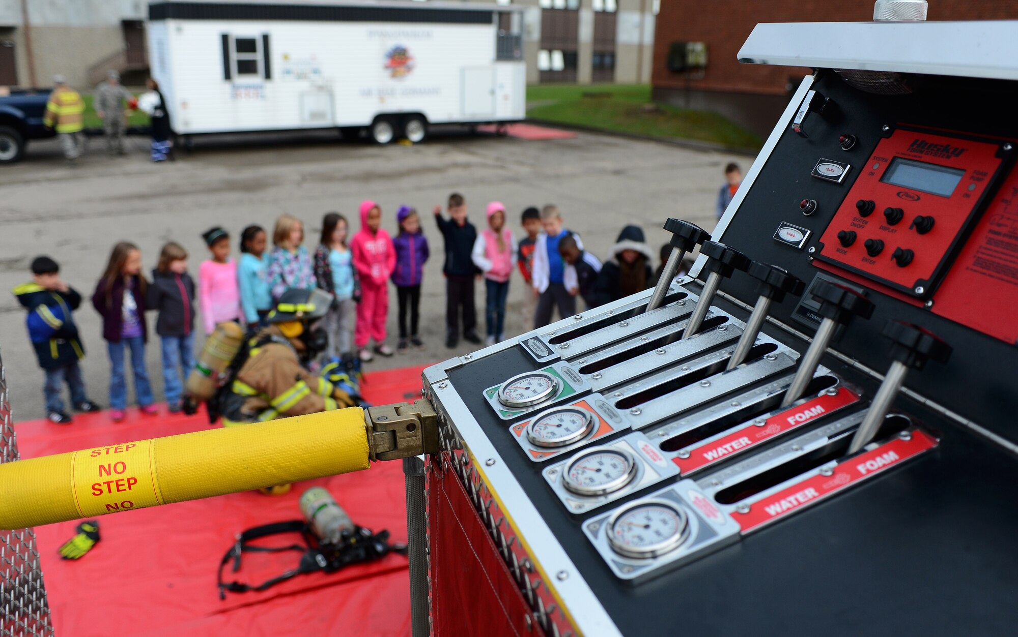 Spangdahlem Elementary School students stand in line outside a fire truck during a visit from the 52nd Civil Engineer Squadron firefighters at Spangdahlem Air Base, Germany, Oct. 8, 2014. The school visit observed Fire Prevention Week which also includes fire-safety demonstrations in front of the Exchange Oct. 10 from 10 a.m. to 2 p.m. (U.S. Air Force photo by Airman 1st Class Luke J. Kitterman/Released)