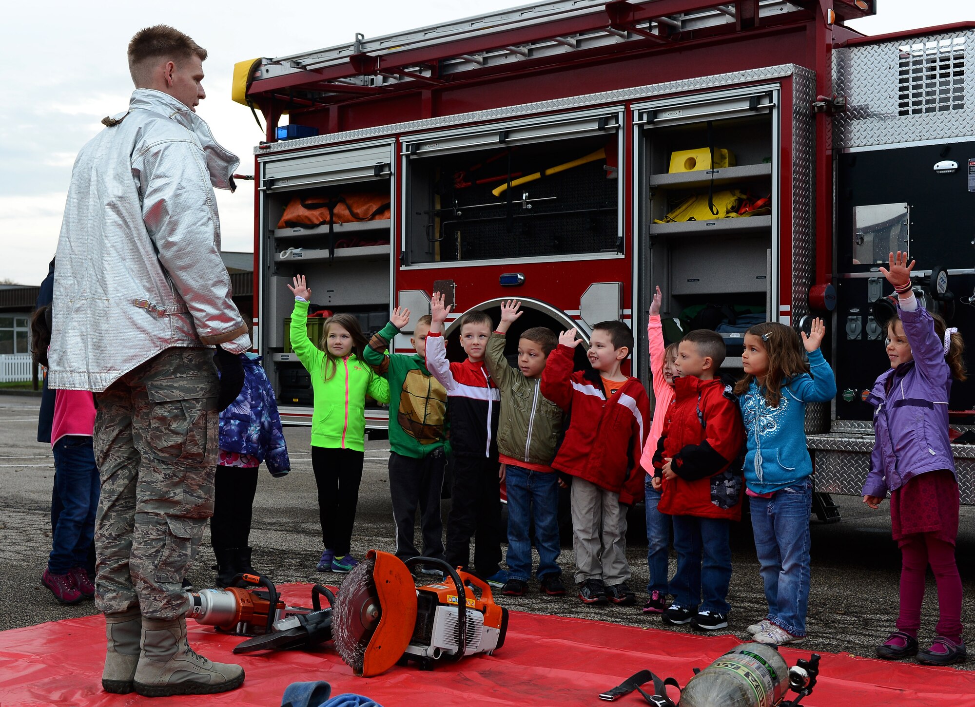 U.S. Air Force Tech. Sgt. Andrew J. Kehl, a 52nd Civil Engineer Squadron firefighter and native of Palm Springs, Calif., talks to a class about being a firefighter while visiting Spangdahlem Elementary School at Spangdahlem Air Base, Germany, Oct. 8, 2014. Fire Prevention Week includes school visits from the 52nd CES firefighters along with many other events. (U.S. Air Force photo by Airman 1st Class Luke J. Kitterman/Released)