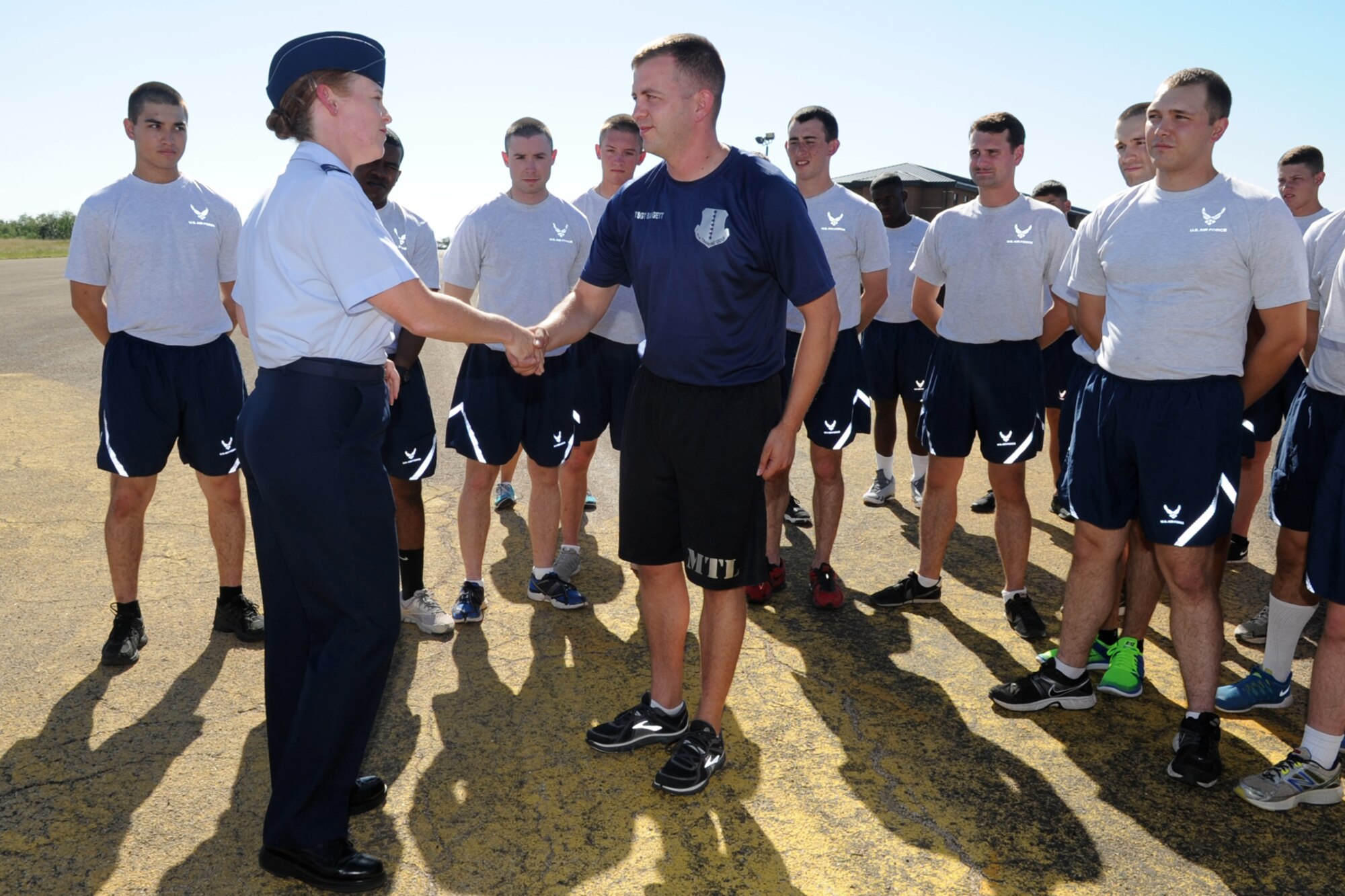 GOODFELLOW AIR FORCE BASE, Texas -- Col. Kimberlee P. Joos, 17th Training Wing Commander, coins Tech. Sgt. Daniel W. Baggett, 312th Training Squadron military training leader, Oct. 6 recognizing him for his leadership demonstration. Before the Air Force Ball Sept. 19, Baggett addressed the student members of the 312th TRS and asked if any of them were interested in attending the ball, hinting at sponsored tickets without letting on that five of the tickets purchased were from him. (U.S. Air Force photo/ Staff Sgt. Laura R. McFarlane)