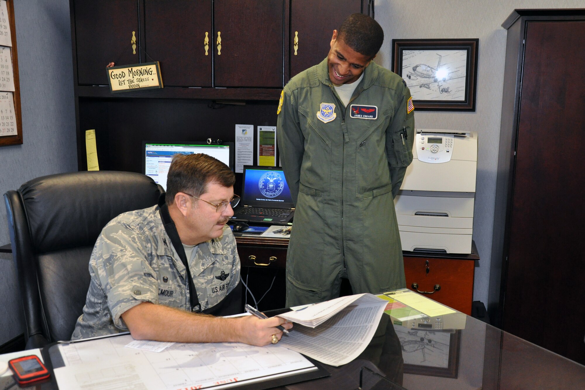 Col. Gregory Gilmour, 916th Air Refueling Wing commander, is assisted by Capt. James Erkard, 911th Air Refueling Squadron, in finalizing his pledge for the Combined Federal Campaign. Open solicitation ends Oct. 20, 2014. (USAF photo by Staff Sgt. Alan Abernethy, 916ARW/PA)