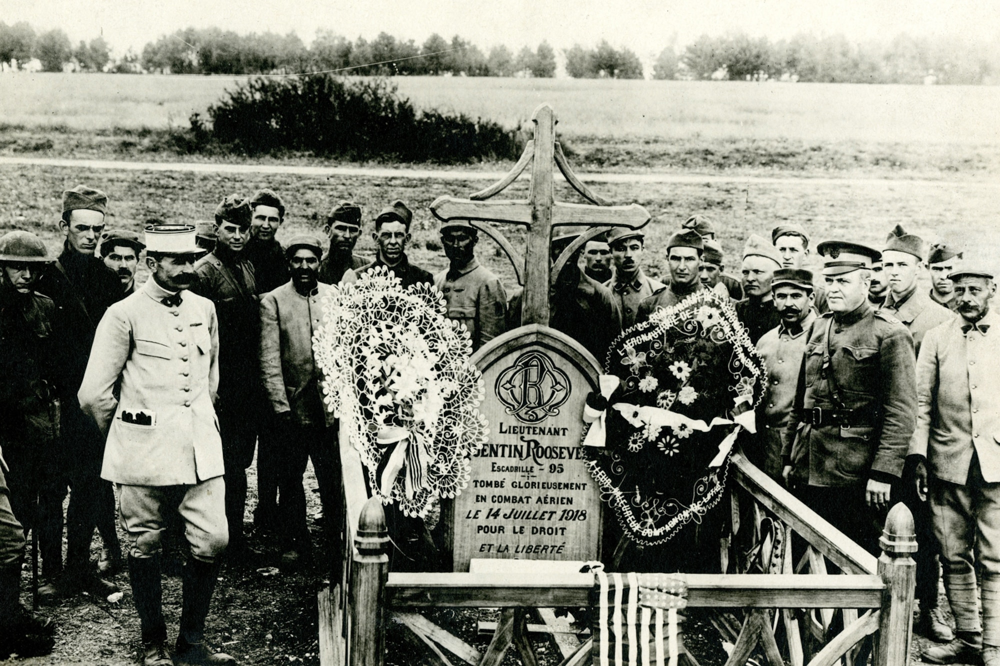 Frencmen and American at Roosevelt's grave after the French had installed a new cross, marker, and fence. (U.S. Air Force photo)     